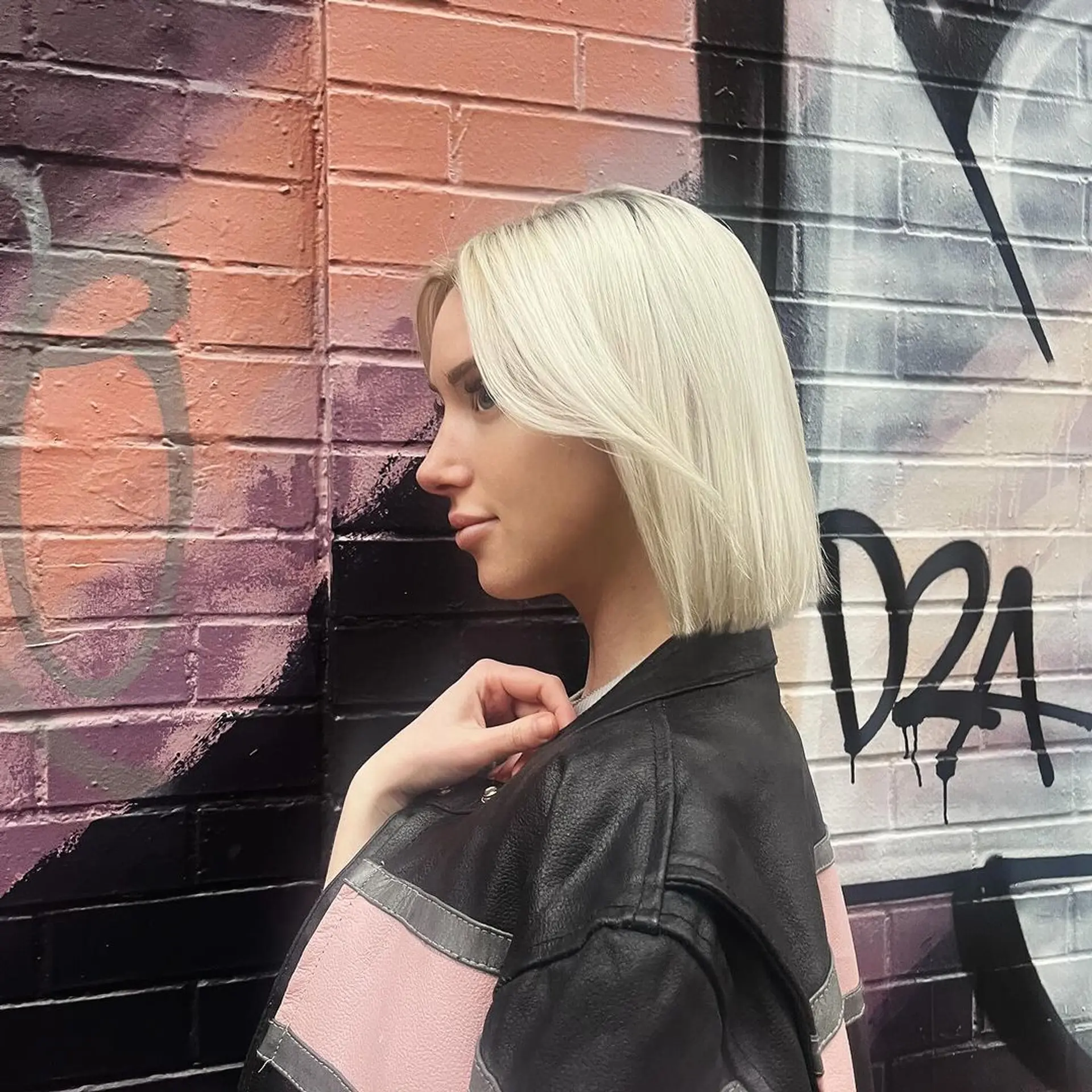 Chic platinum bob with a side part, sleek and straight texture, blunt ends, and shoulder-length cut. 2