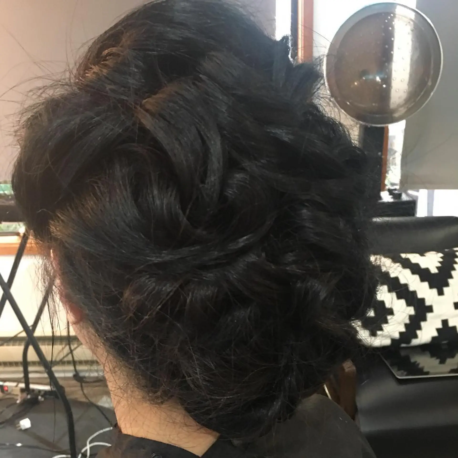 A full, textured updo crafted with soft, interwoven curls gathered at the back. 1