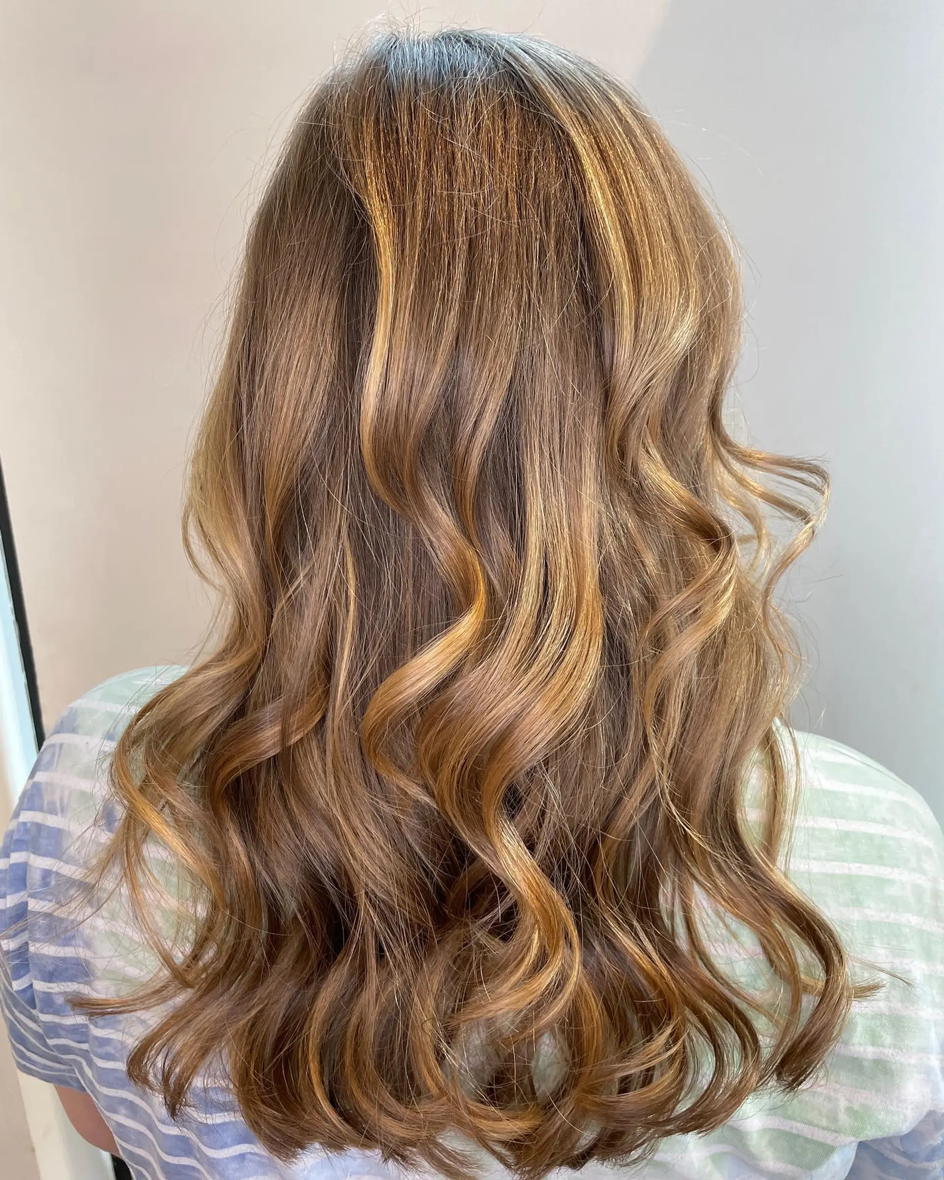 Long, wavy hair with a golden blonde balayage. 1