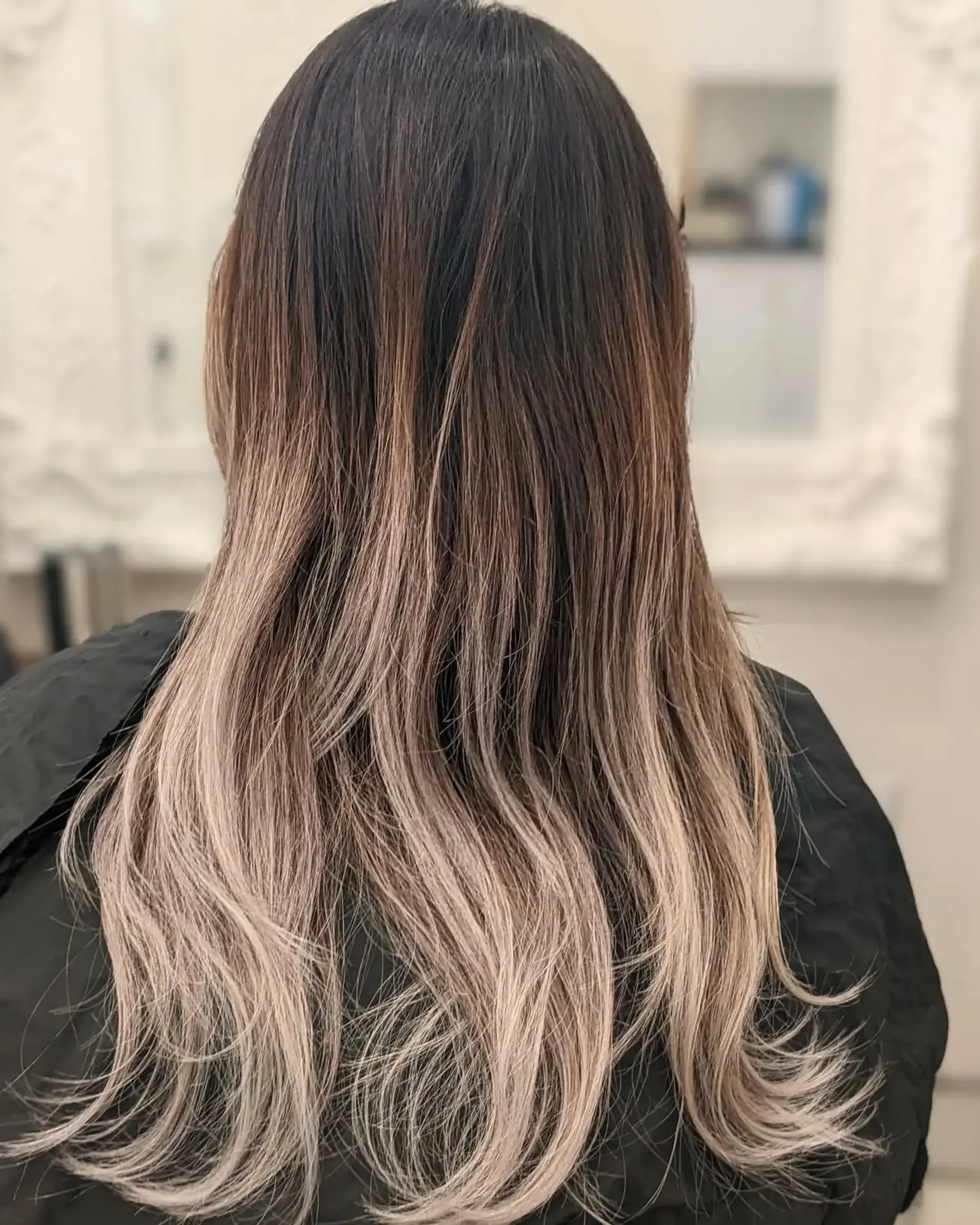 Long, wavy hair with a dark to ash blonde ombre and layered ends. 1