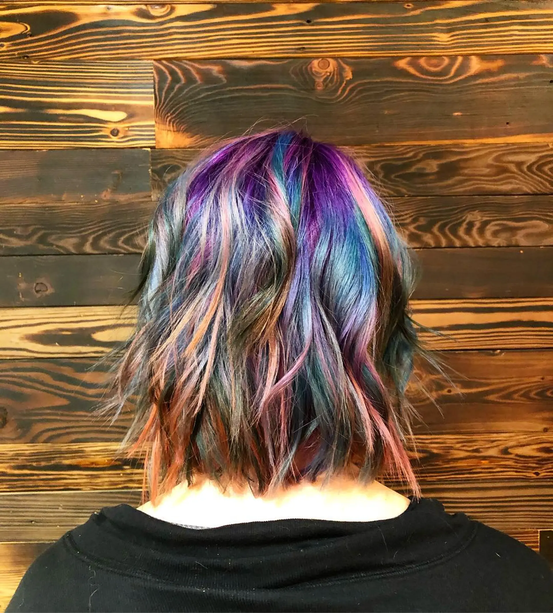 A medium-length shaggy bob with a rainbow melt color palette. 1
