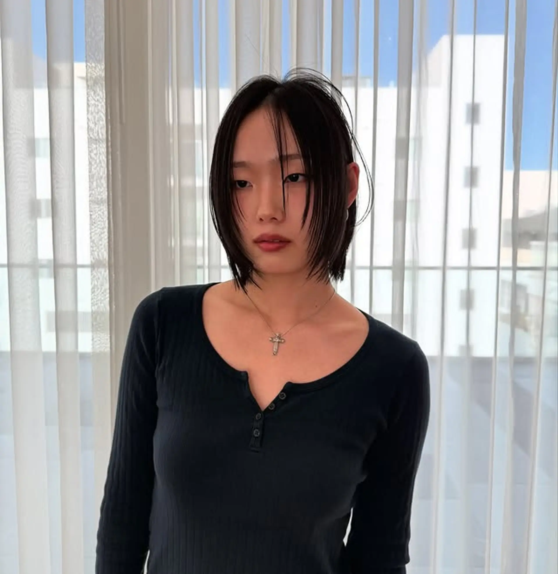 A chin-length shaggy bob with choppy layers and textured ends. 1