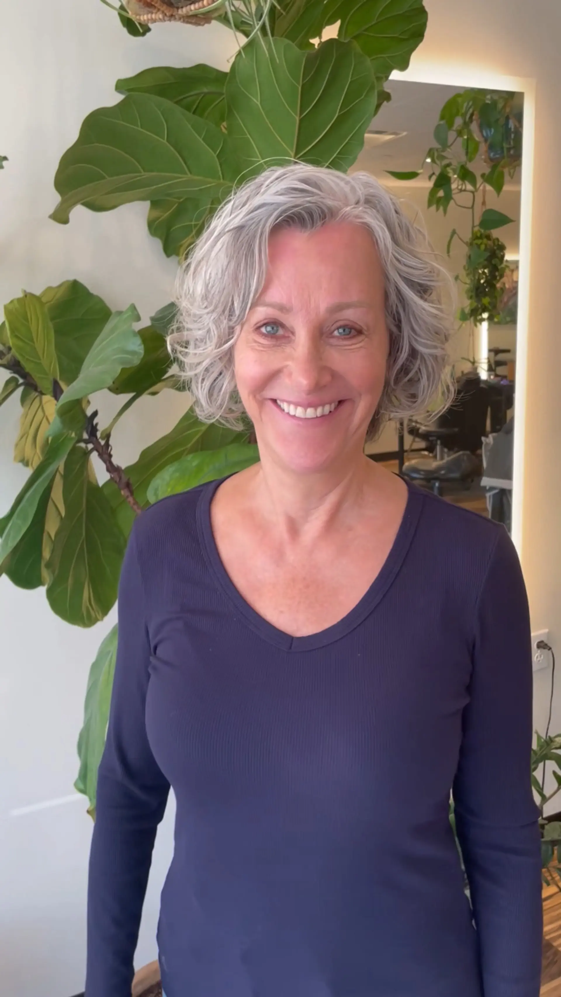 A chin-length layered bob with soft, defined waves and natural silver-grey volume. 1