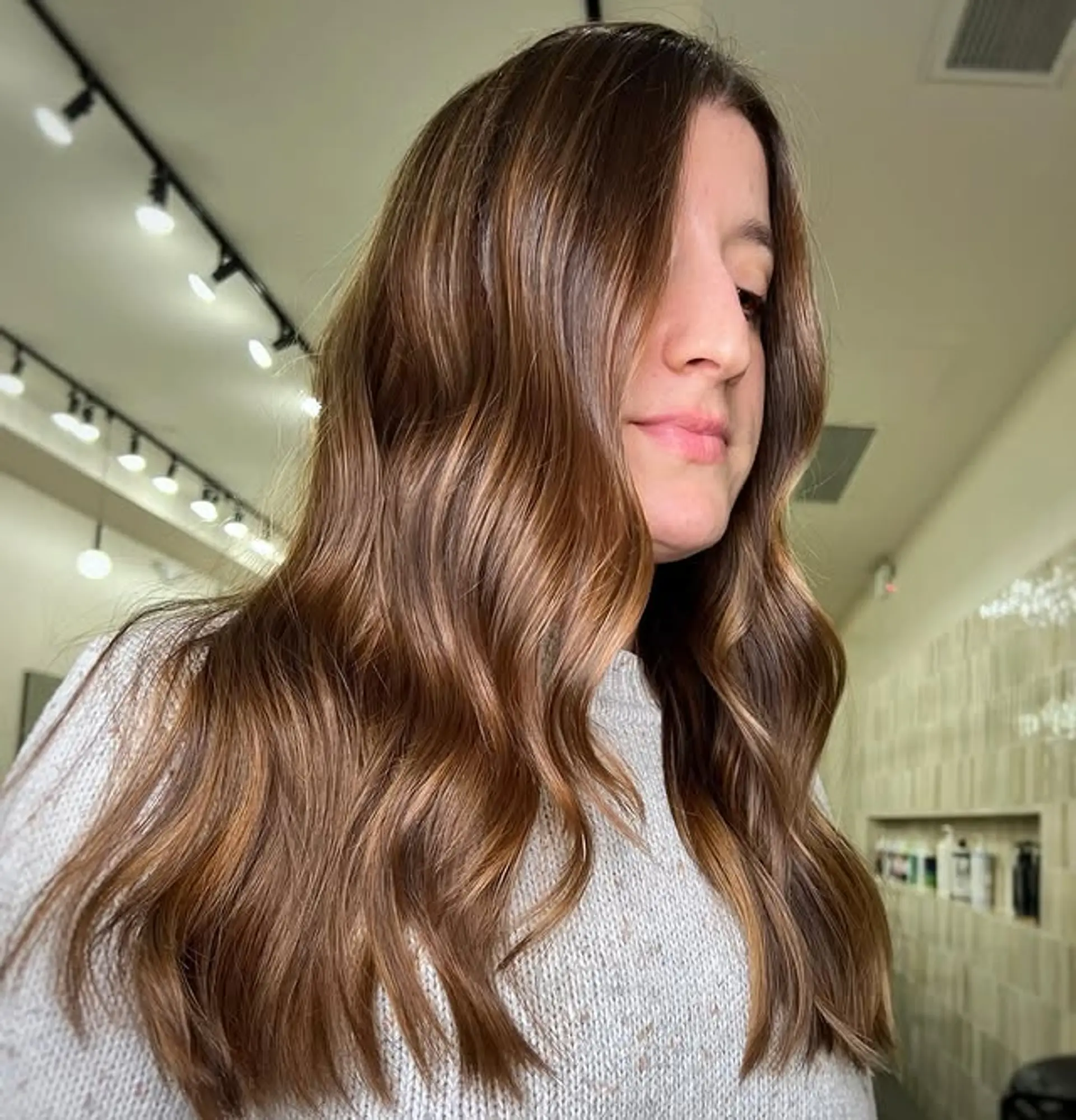 Long, bronzed wavy hair with caramel highlights. 1