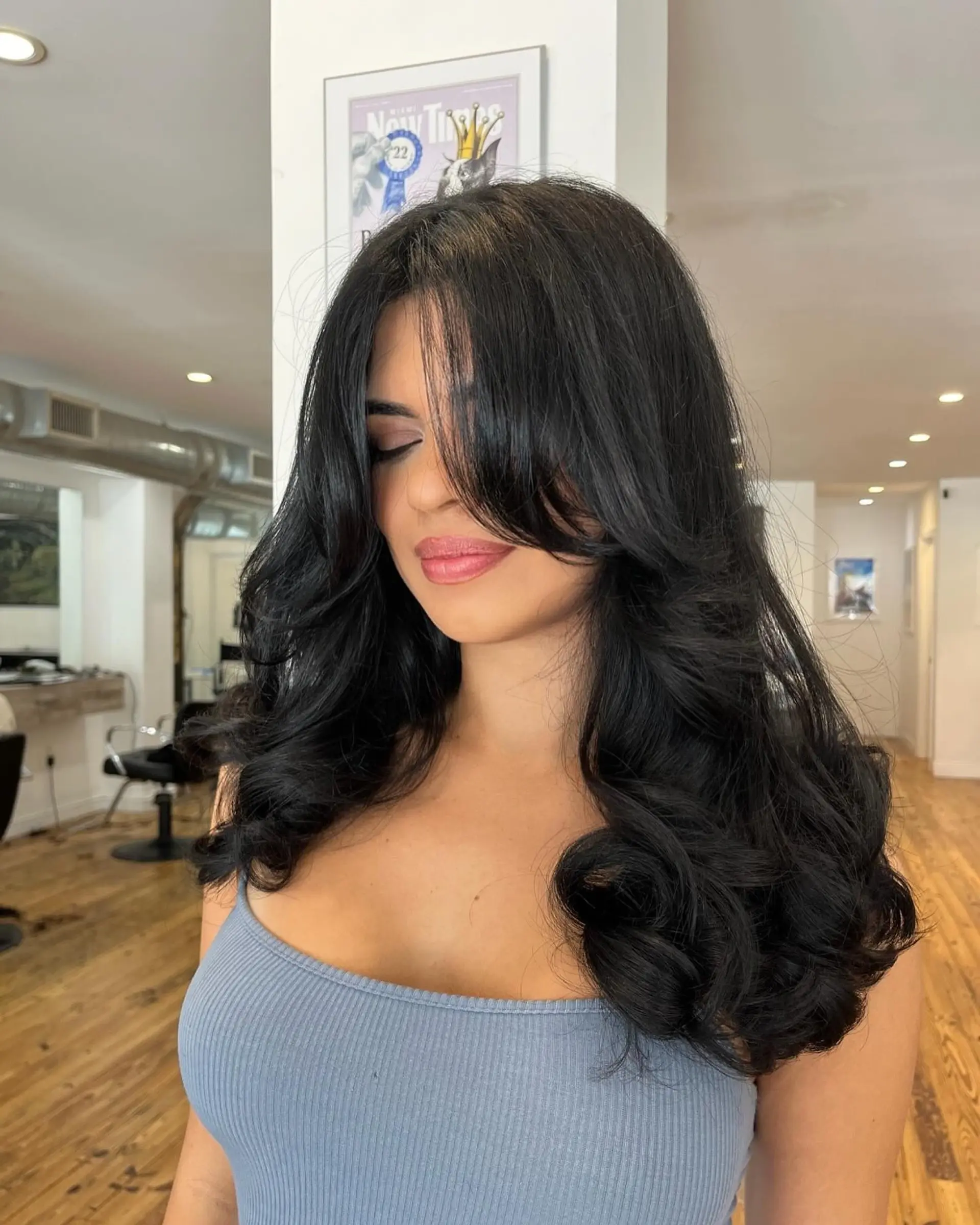 Long, layered waves with face-framing curtain bangs. 1