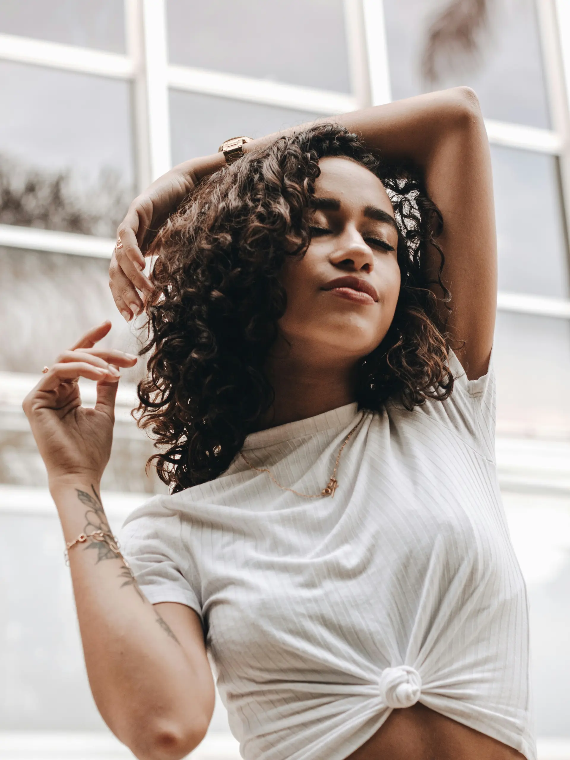 Medium-length defined brunette curls styled with soft volume and touchable texture. 1