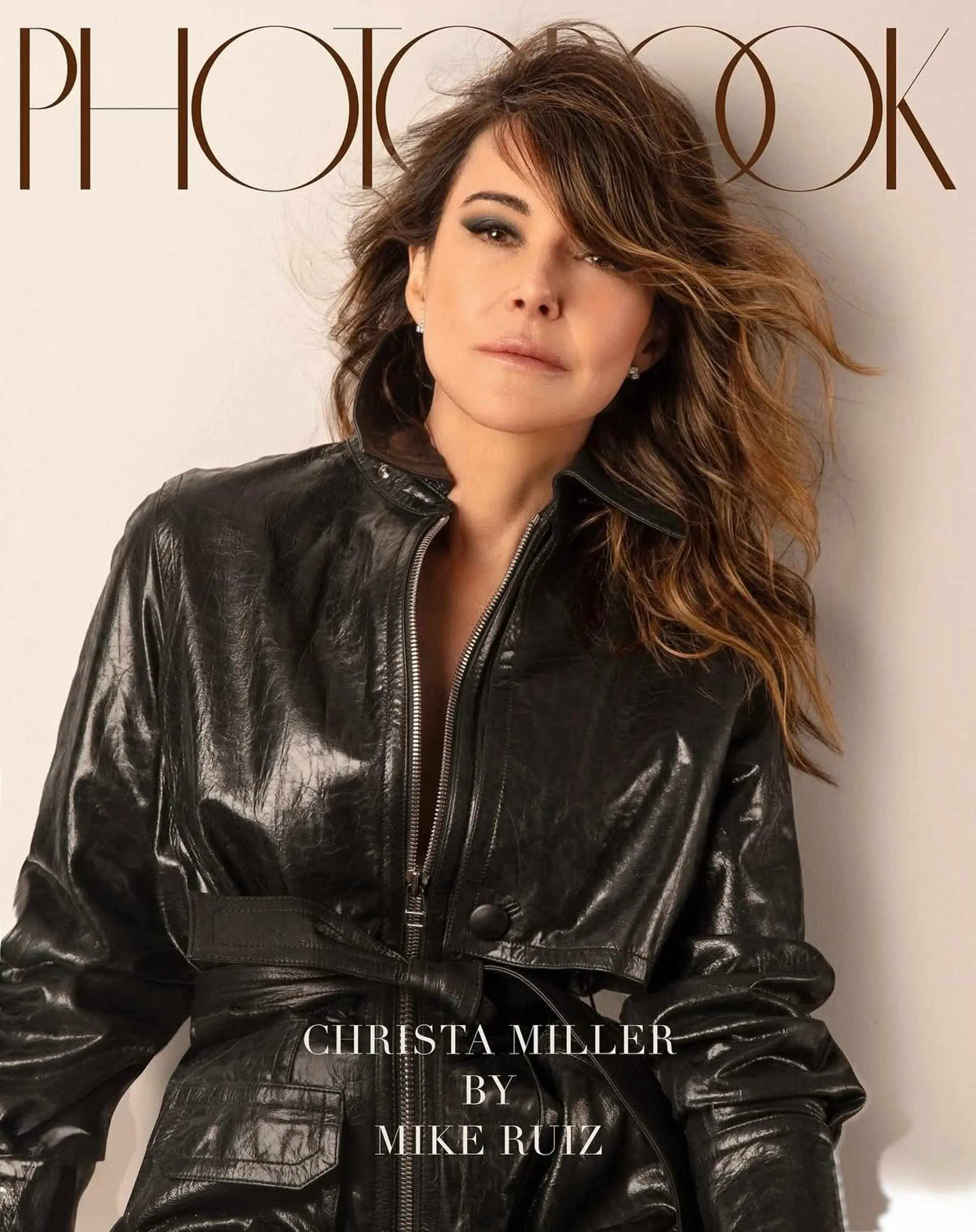 A textured, medium-length layered cut styled with tousled waves, a deep side-swept fringe, and subtle caramel highlights. 1