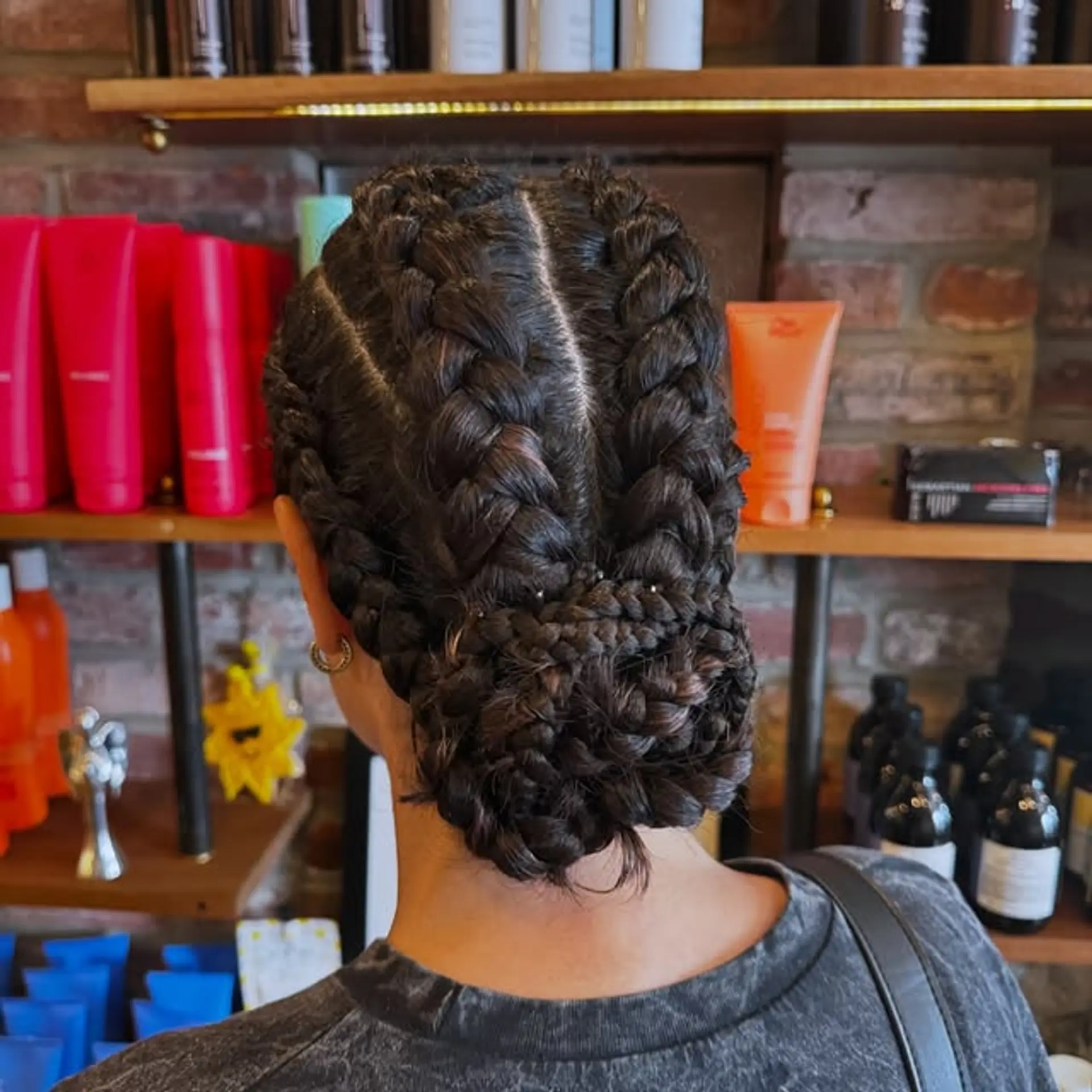 An elegant braided updo, styled into a low bun. 1