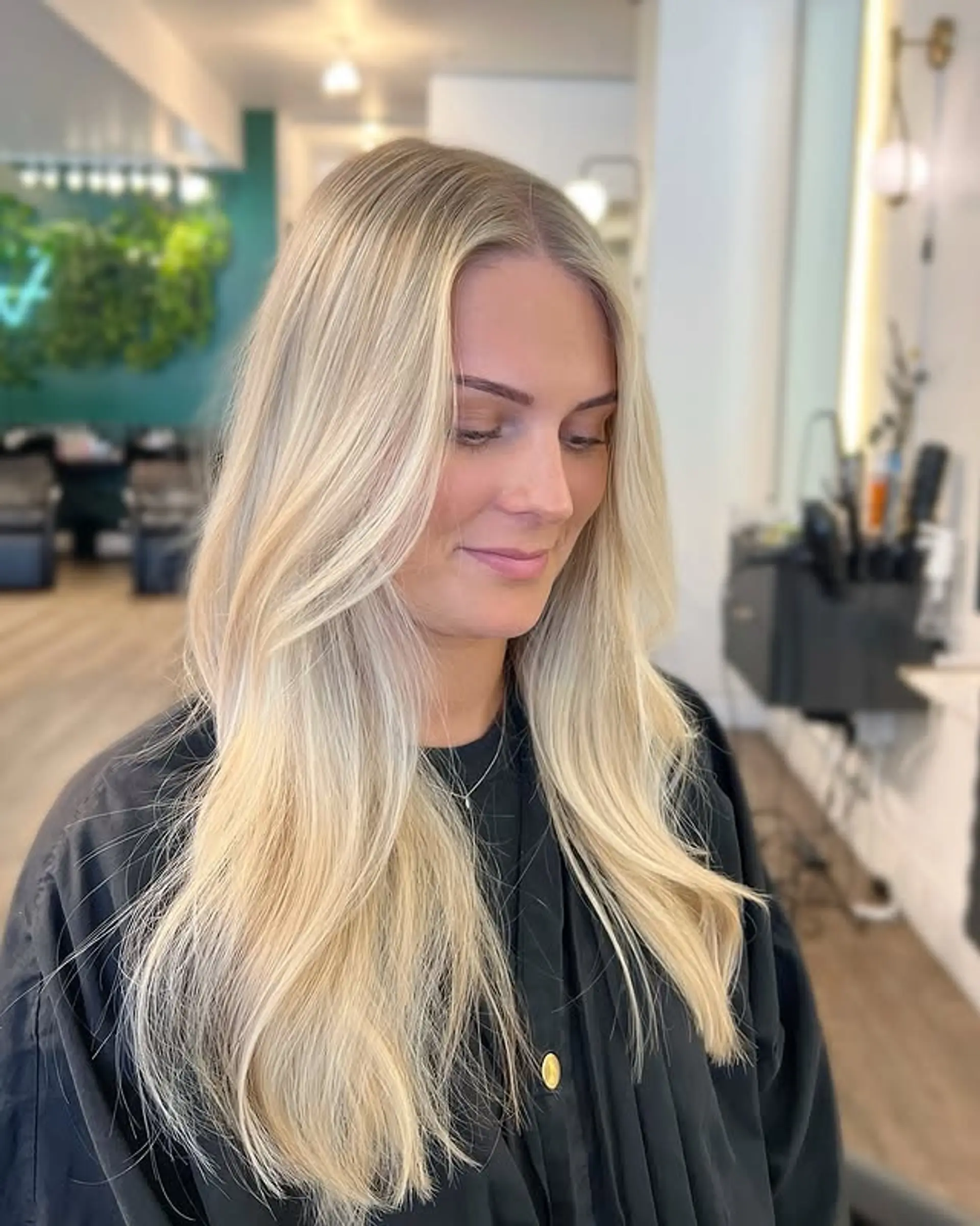 Long layered hair with soft waves and face-framing layers. 1