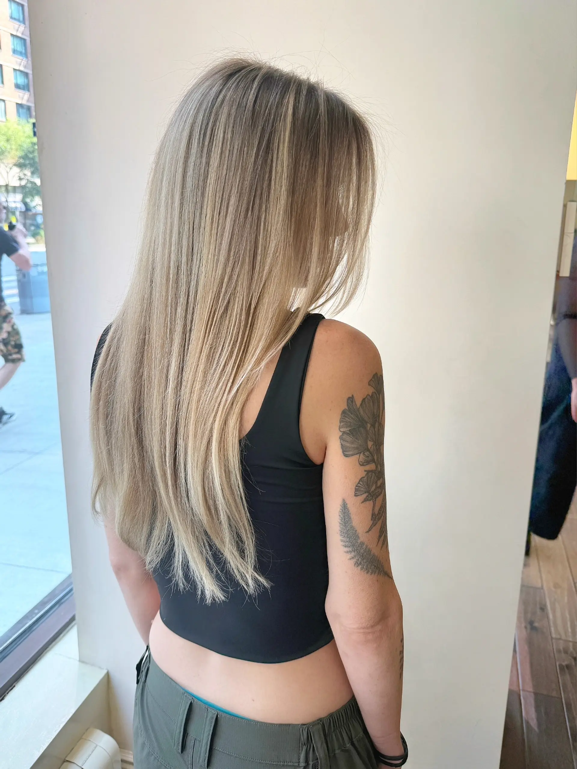 Sleek, straight long hair styled smoothly down the back, featuring seamless blonde highlights with soft dimension. 1