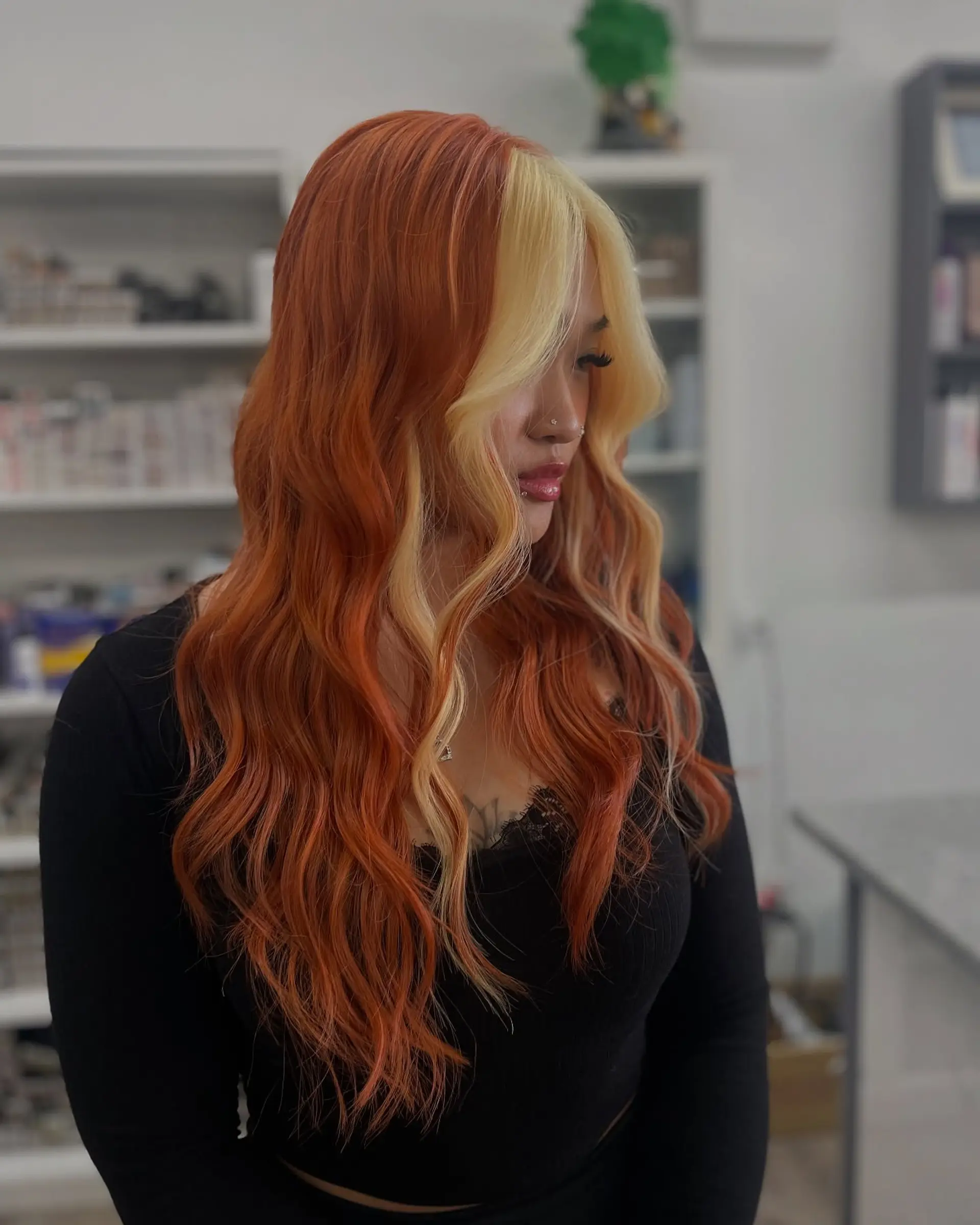 A long, wavy hairstyle featuring a copper base color with a contrasting blonde money piece. 1