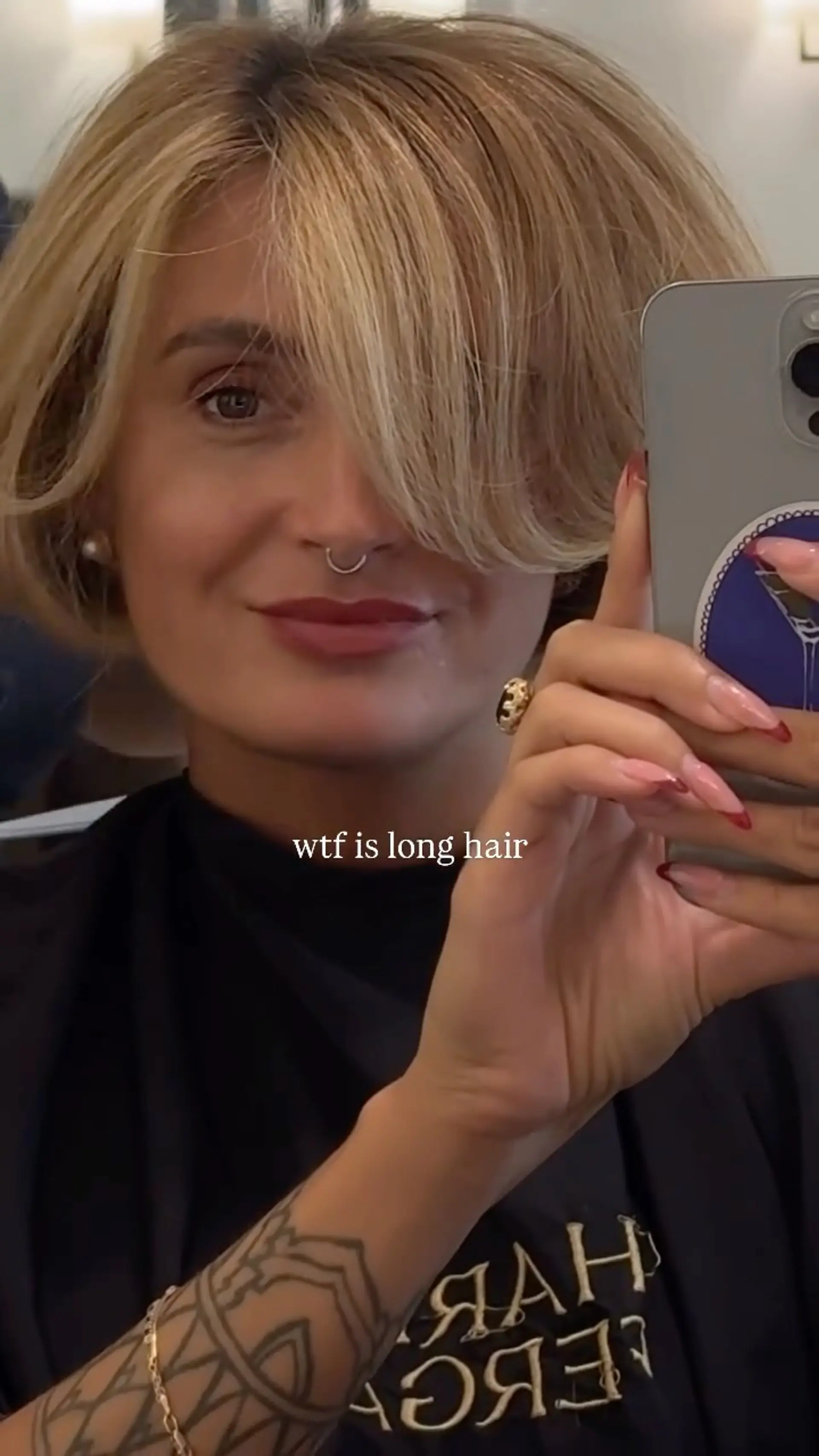 A rounded, voluminous short bob haircut featuring feathered side-swept bangs that sweep past the brow. 1