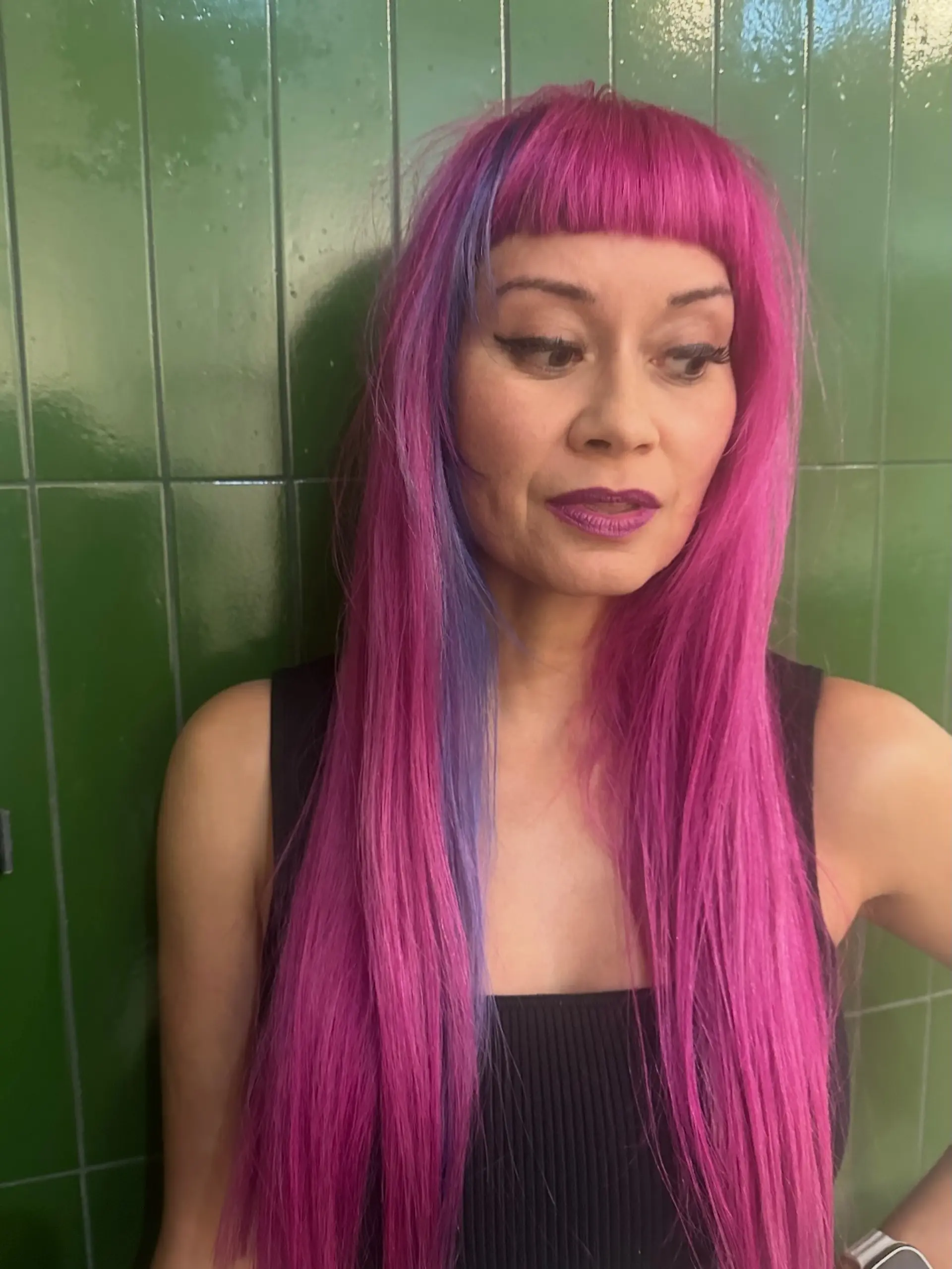 Vibrant hot pink long straight hair featuring blunt micro bangs and a contrasting purple-blue accent streak. 1
