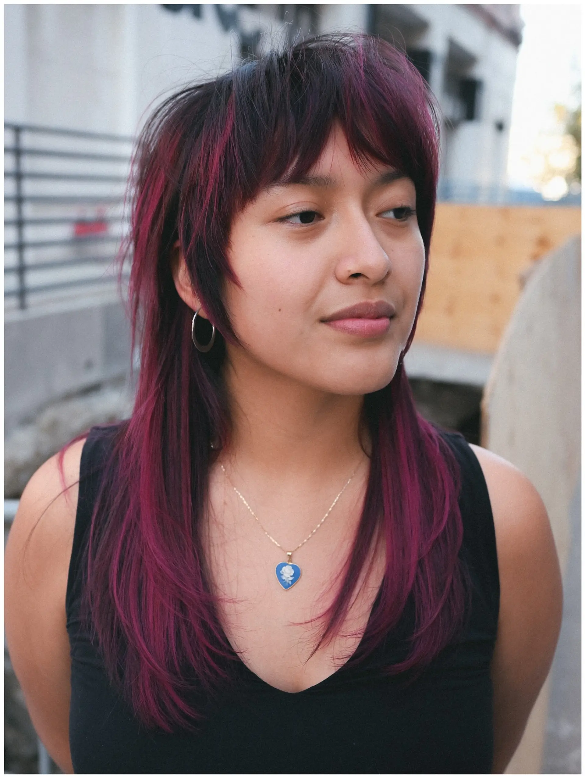 A textured shag mullet featuring a choppy fringe, face-framing layers, and vivid magenta-purple highlights on dark hair. 1