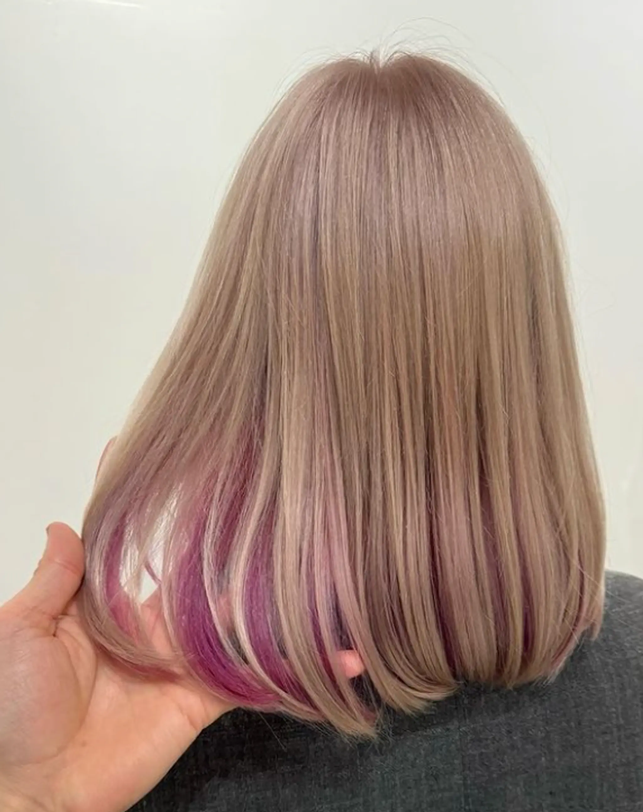 Medium-length, straight, ash blonde hairstyle with subtle lilac and violet underlayer and blunt cut ends. 1