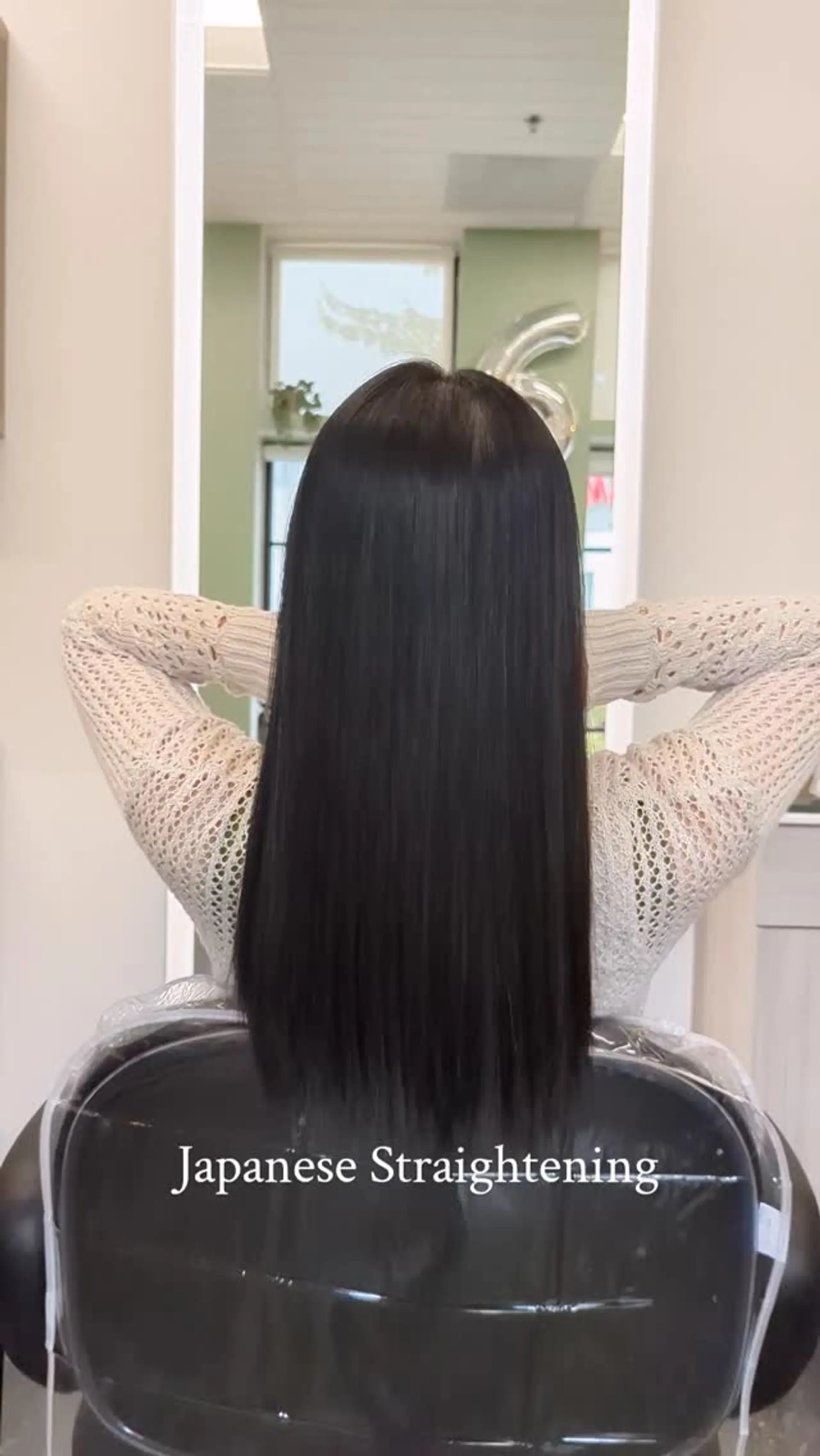 Ultra-smooth, glossy black hair straightened to a sleek, pin-straight finish falling down the back. 1