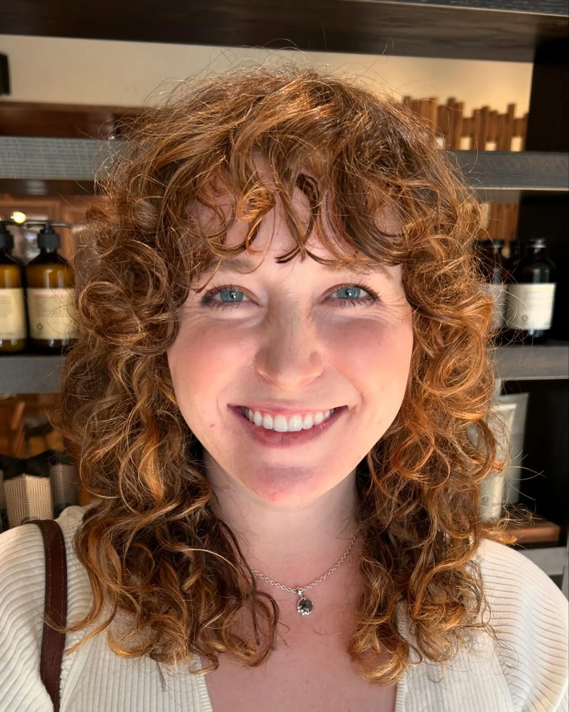 A trendy medium-length curly shag with face-framing bangs. 1