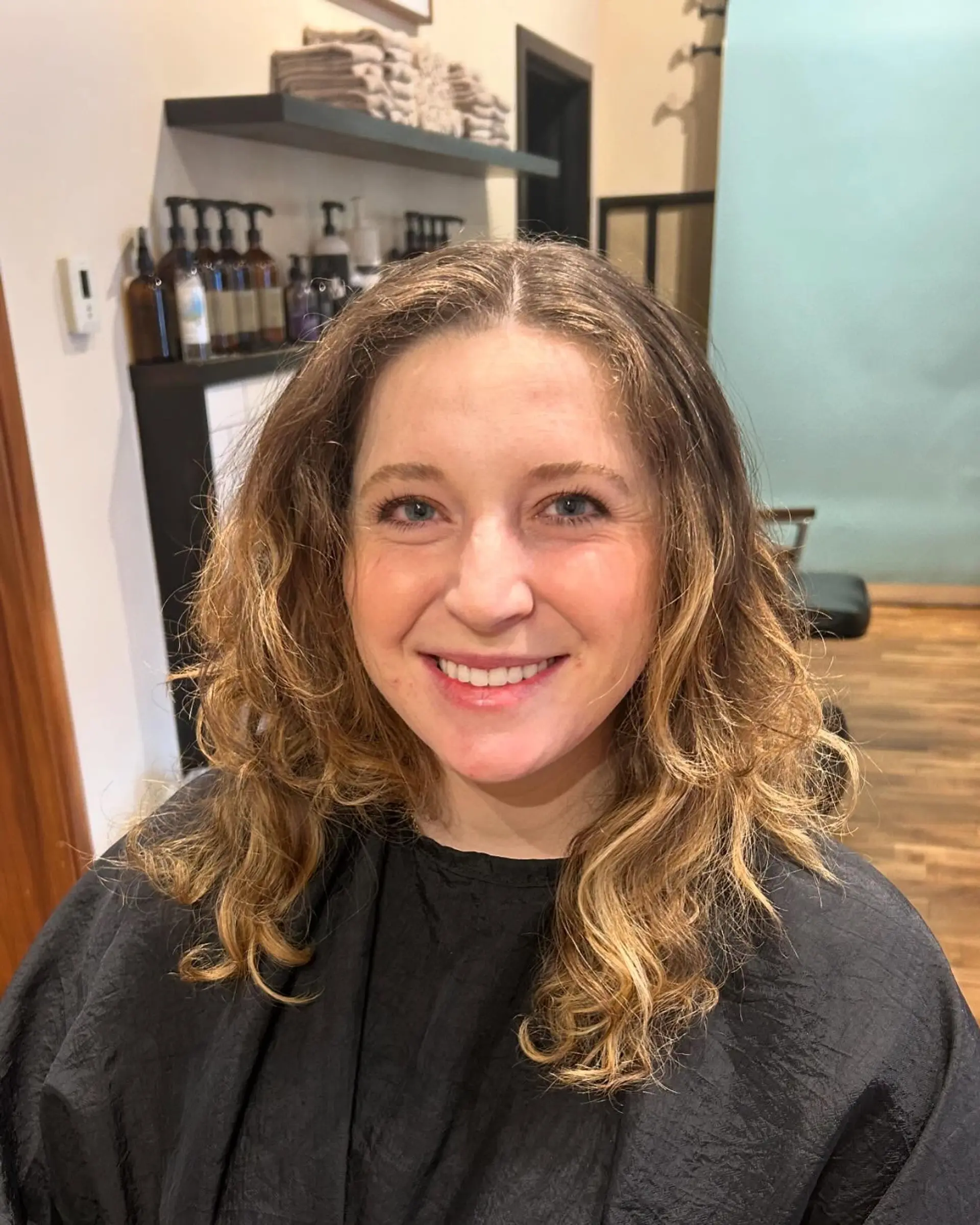 A trendy medium-length curly shag with face-framing bangs. 3