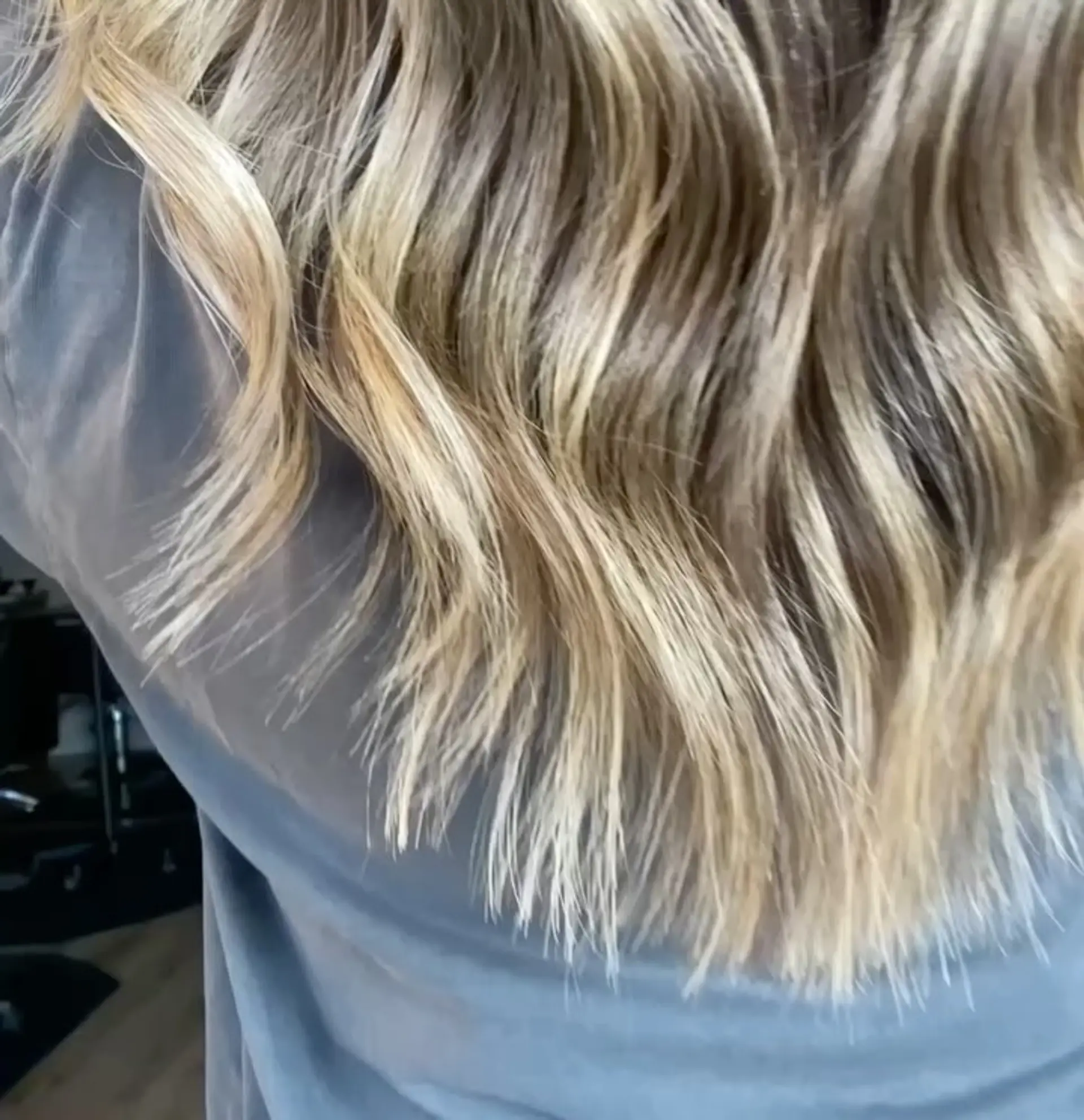 Long wavy hair featuring seamless, blended blonde highlights over a light brown base with soft textured ends. 1