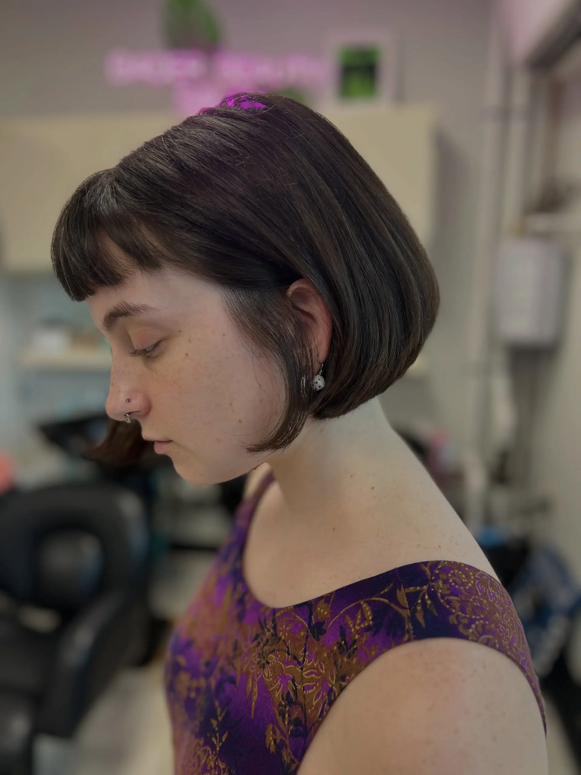 A sleek, chin-length blunt French bob featuring straight micro fringe in a rich dark brown tone. 1