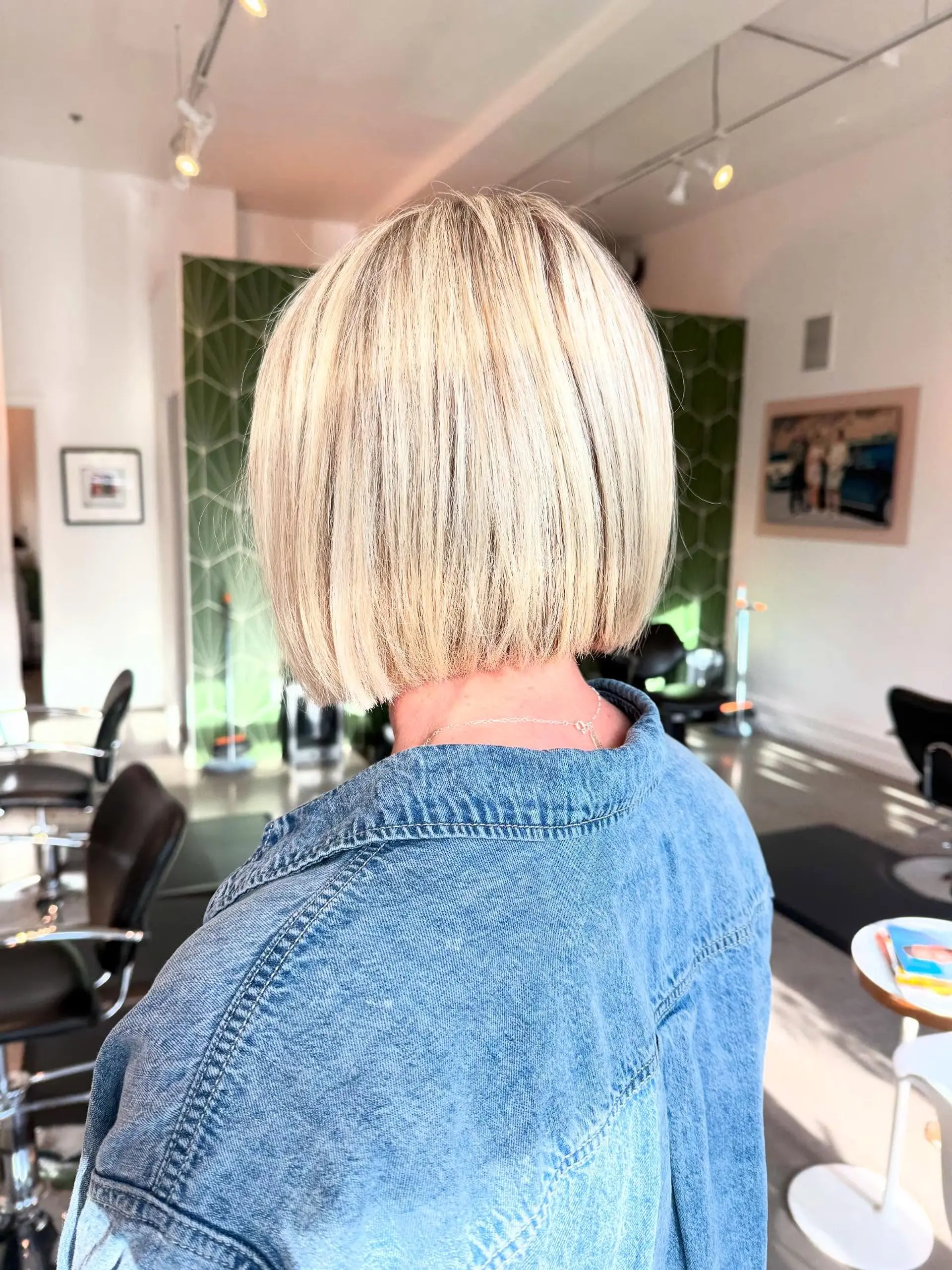A sleek, one-length blunt bob in a bright cool blonde shade. 1