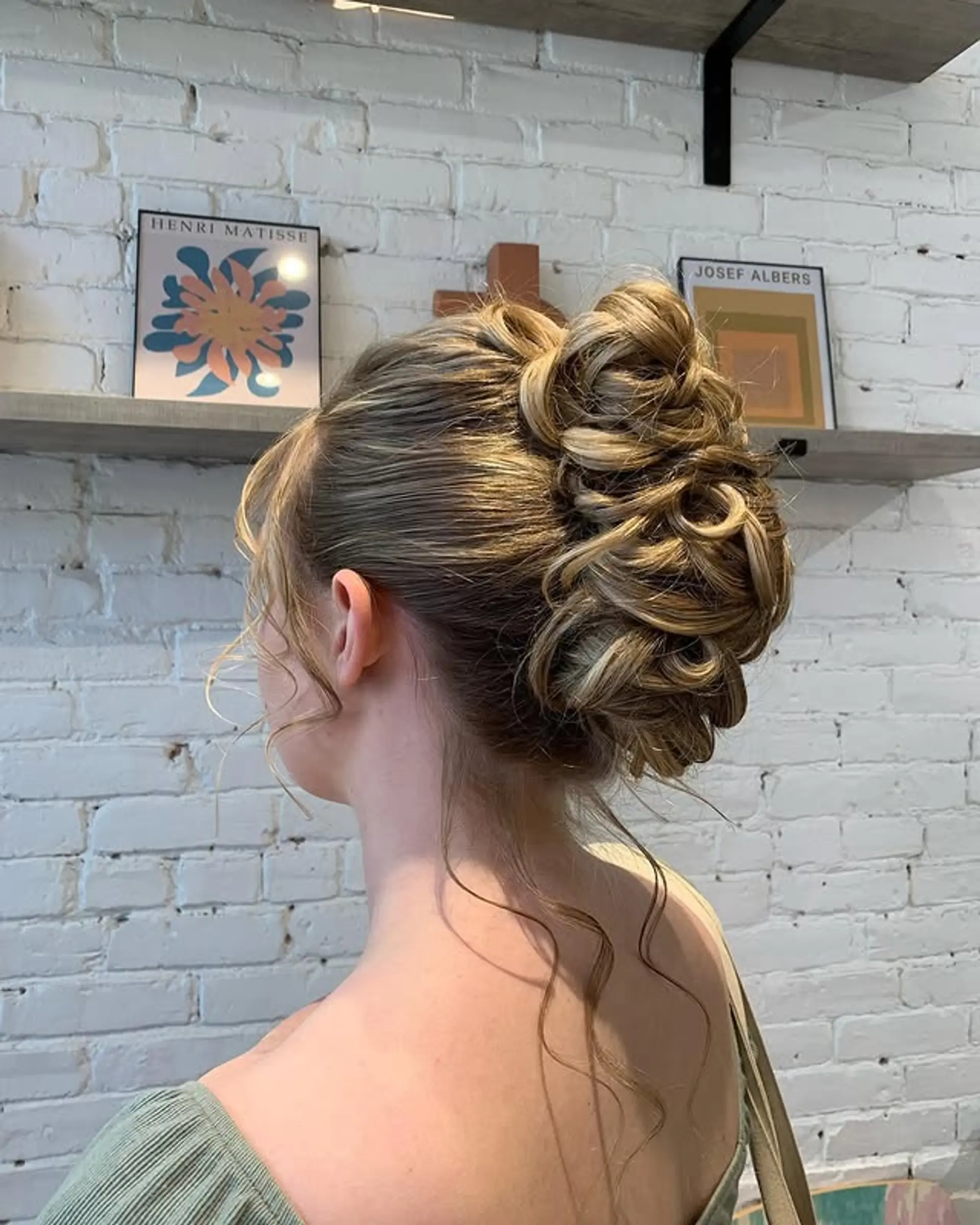 Chic updo with textured waves and face-framing pieces. 1