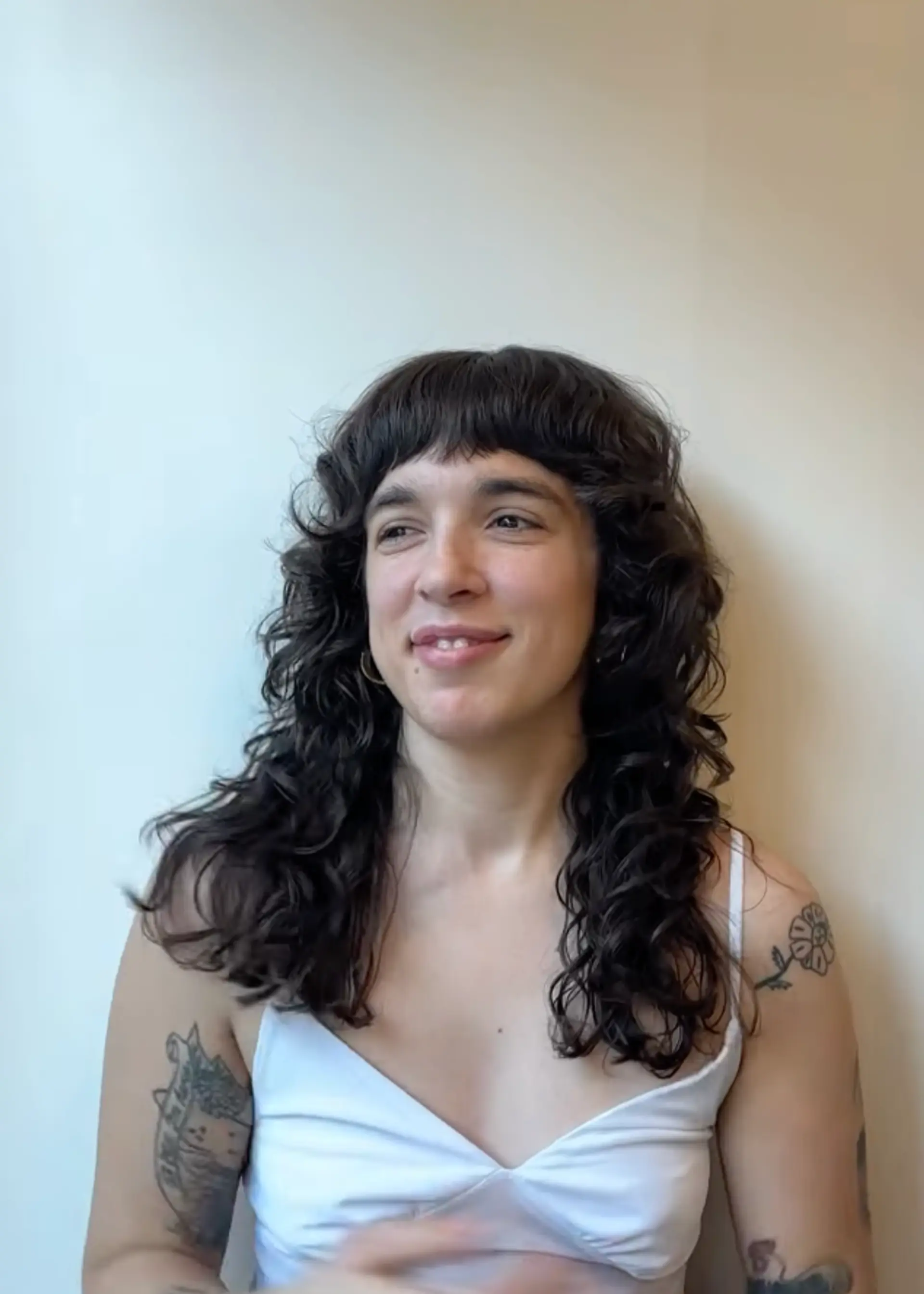 Shaggy haircut with shorter bangs done with both a straight razor and scissors. Styled with Hymn by Reverie 1