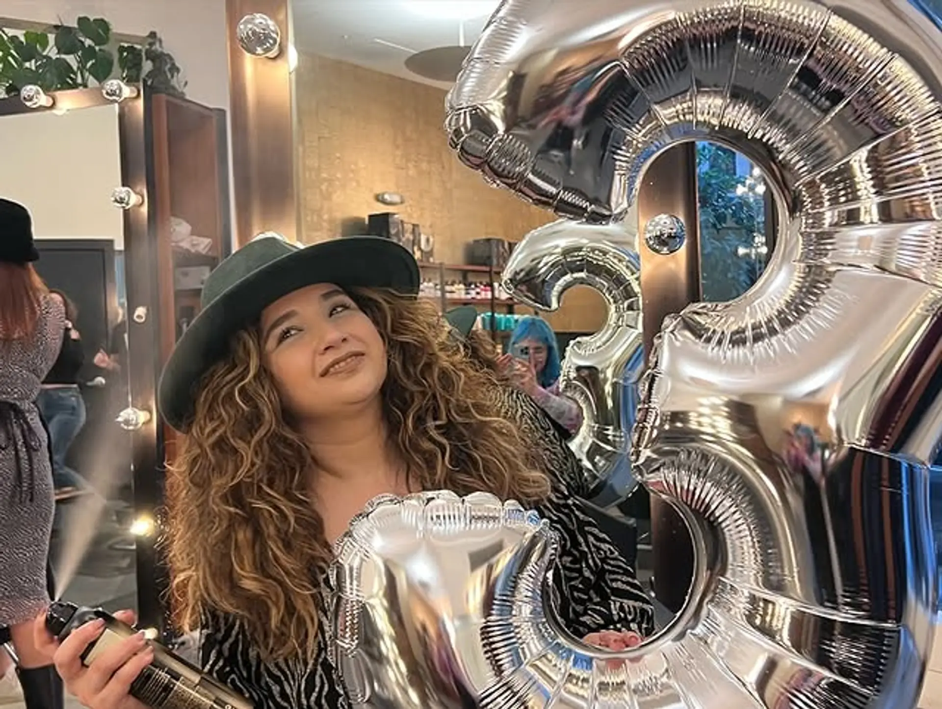 A voluminous curly hairstyle with defined curls and layers. 1