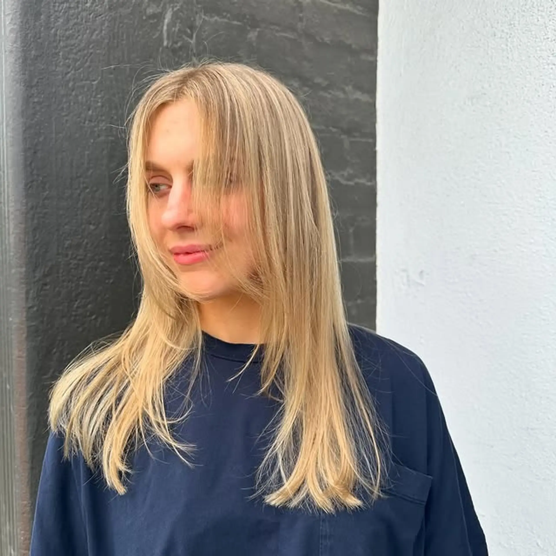 Features curtain bangs and face framing layers. 1