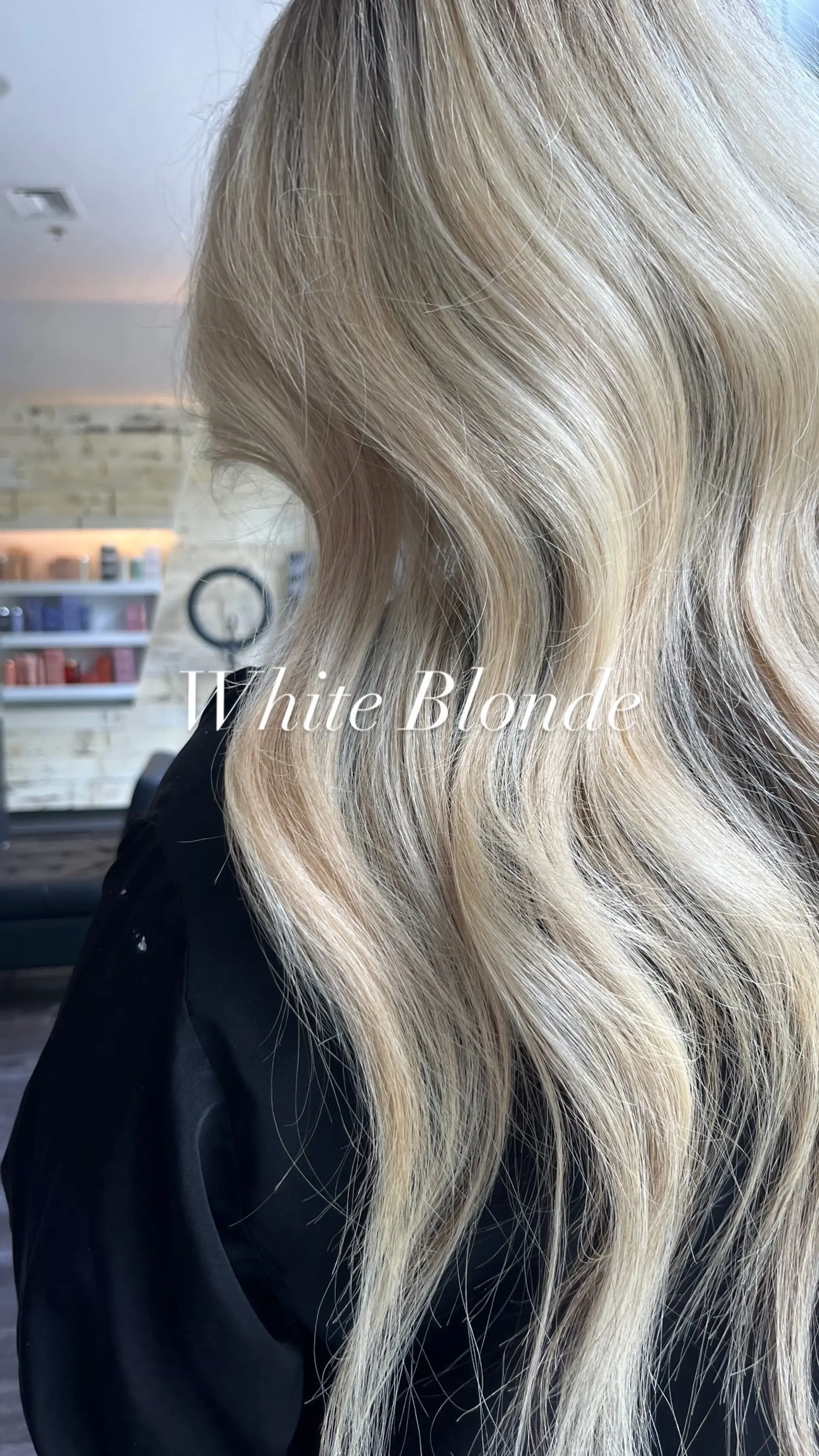 Long white blonde hair styled with soft, cascading loose waves showing subtle root dimension. 1