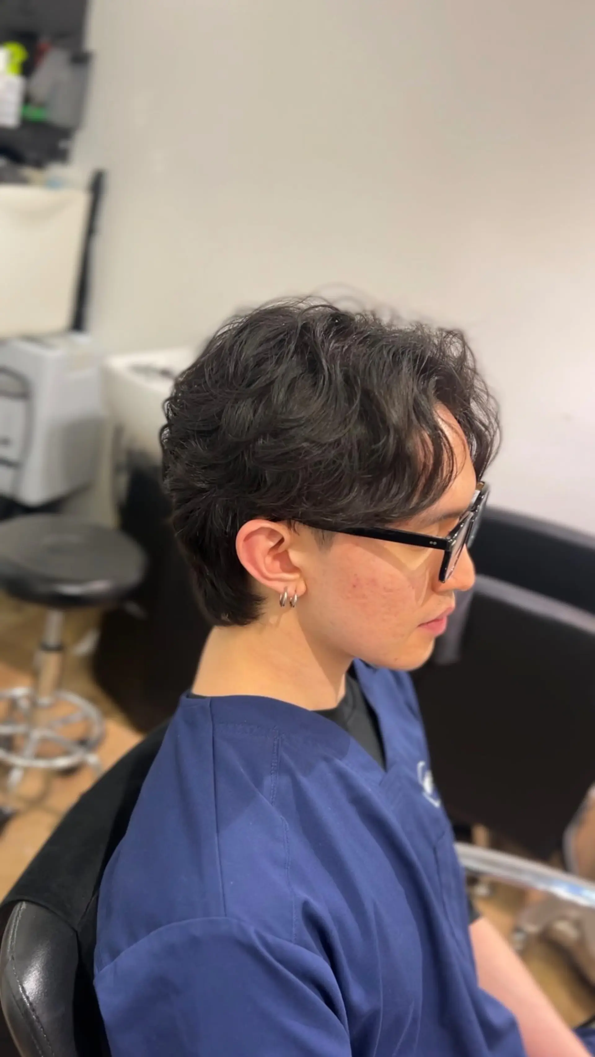 A short, layered haircut enhanced with a soft body wave perm for natural volume and effortless flow. 1