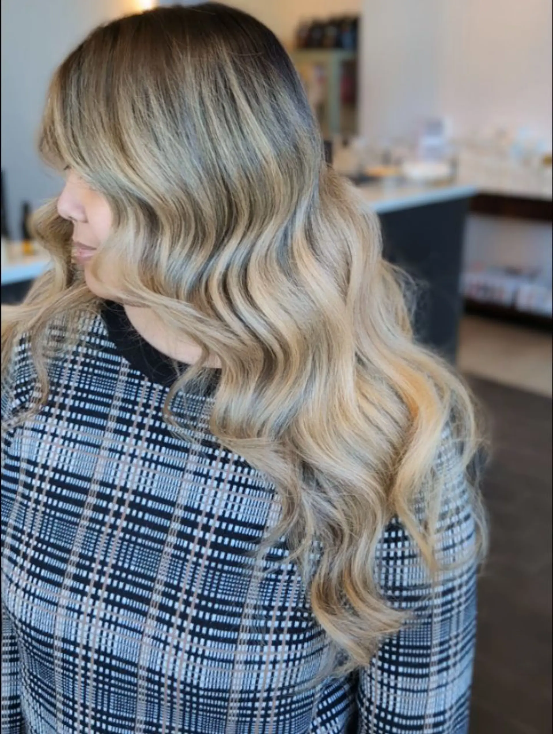 Long hair featuring a seamless foilayage color melt from deep natural roots into cool-toned ash and honey blonde, styled in polished, glamorous waves. 1