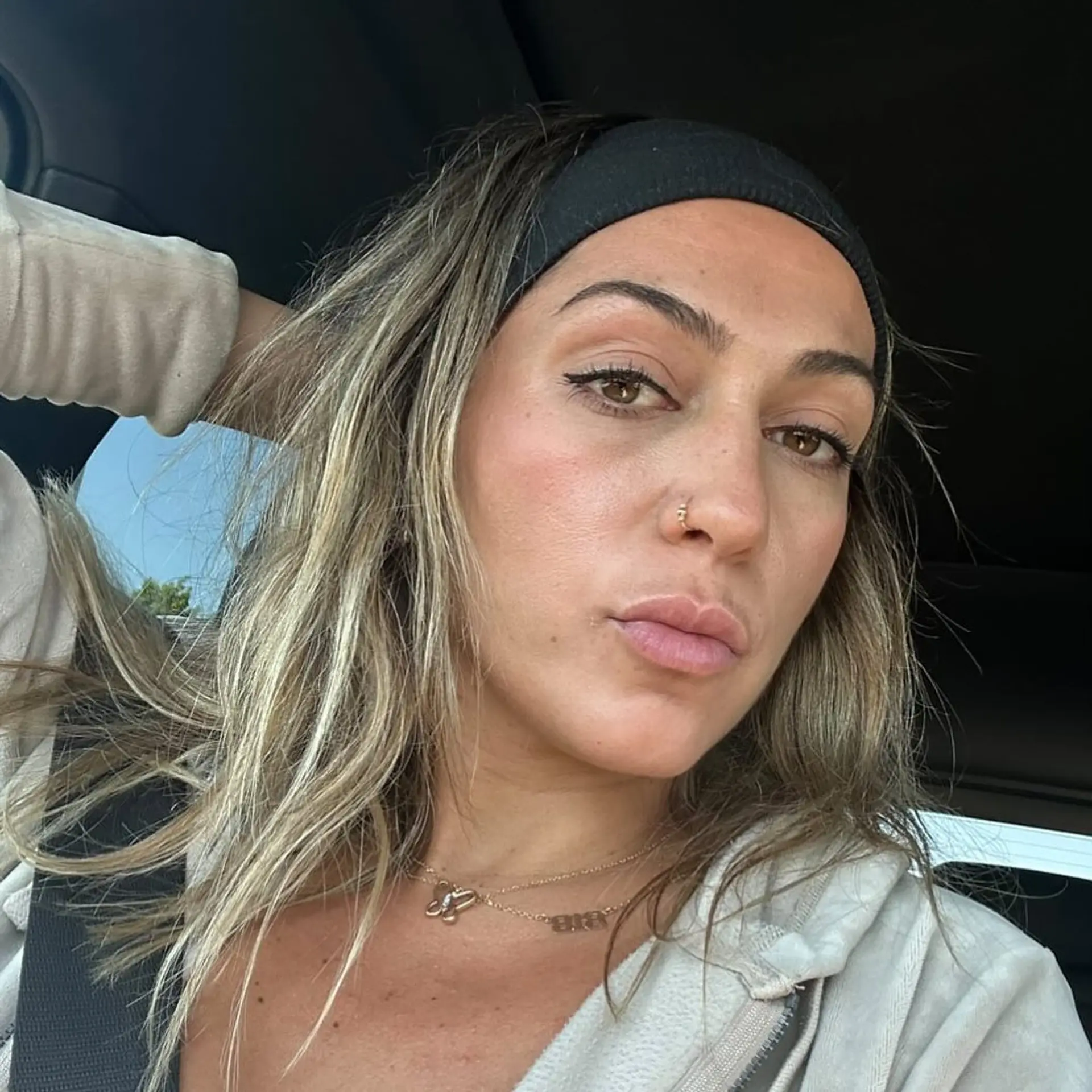 Medium-length hair featuring bright, dimensional blonde highlights over a light brown base, casually styled back with a wide black headband. 1