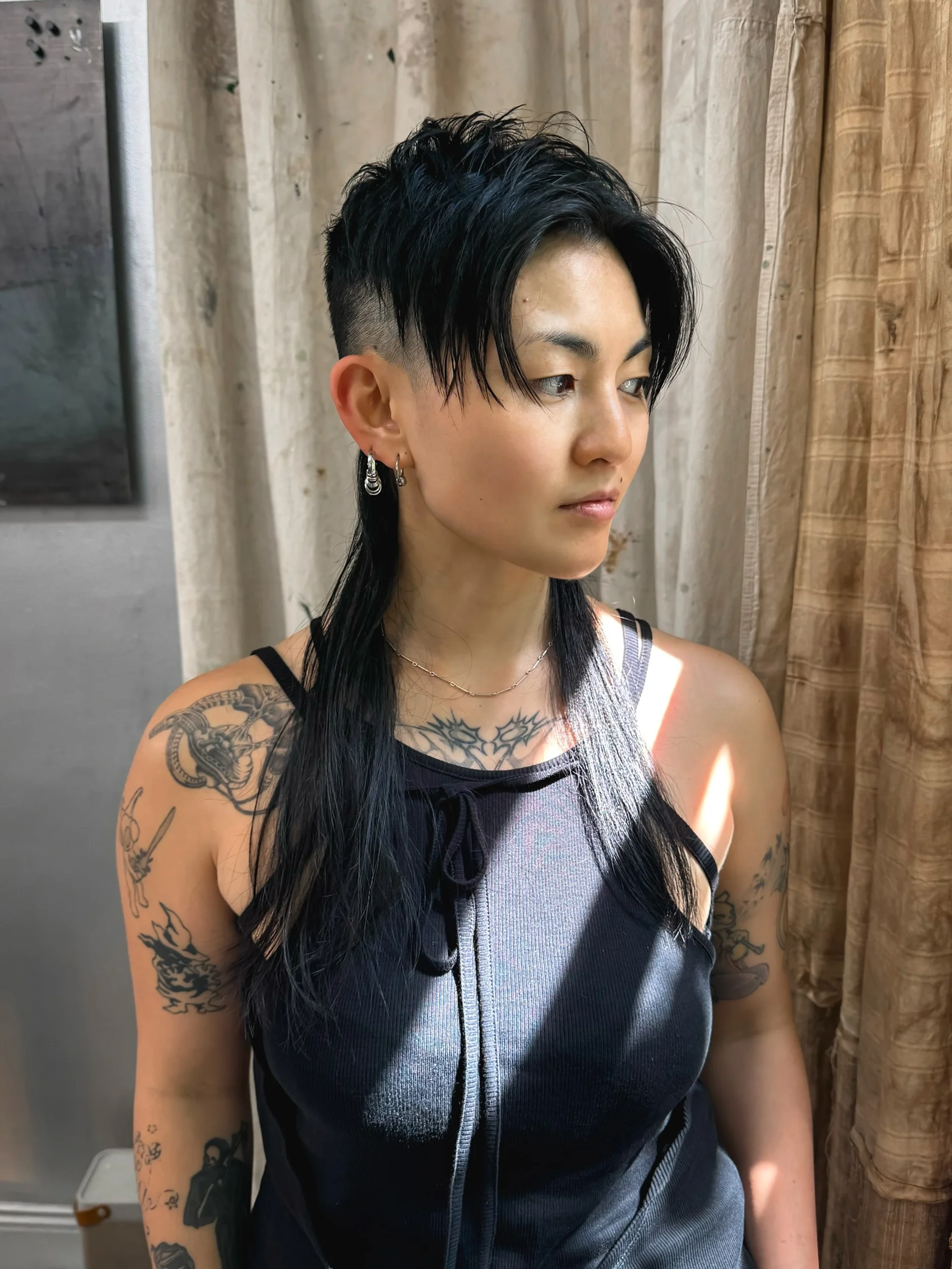 Woman with a modern asymmetrical bob, showcasing an edgy East Village trend - Preview 2