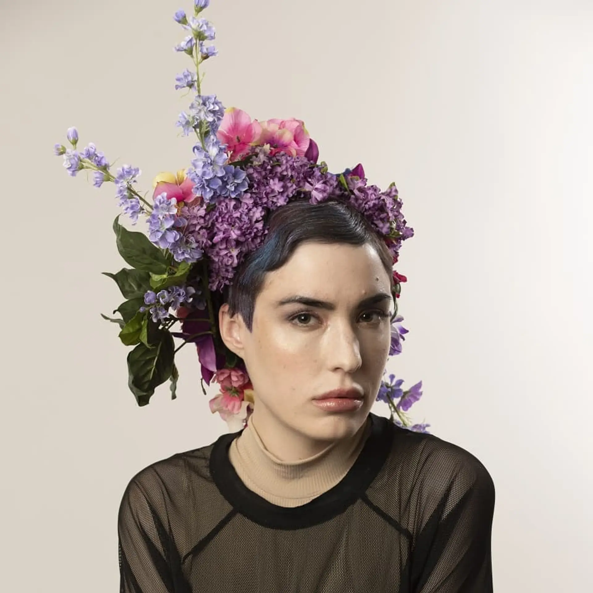 A short, layered pixie cut with bold blue highlights. 1