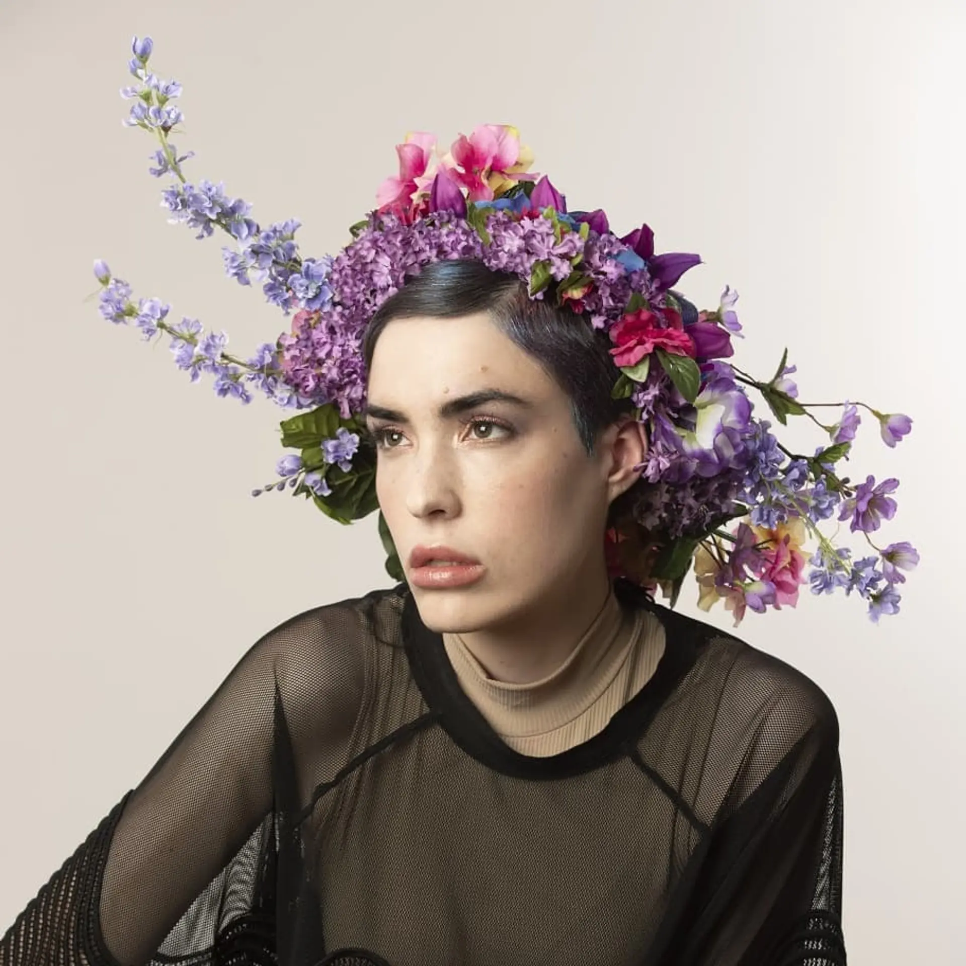 A short, layered pixie cut with bold blue highlights. 2