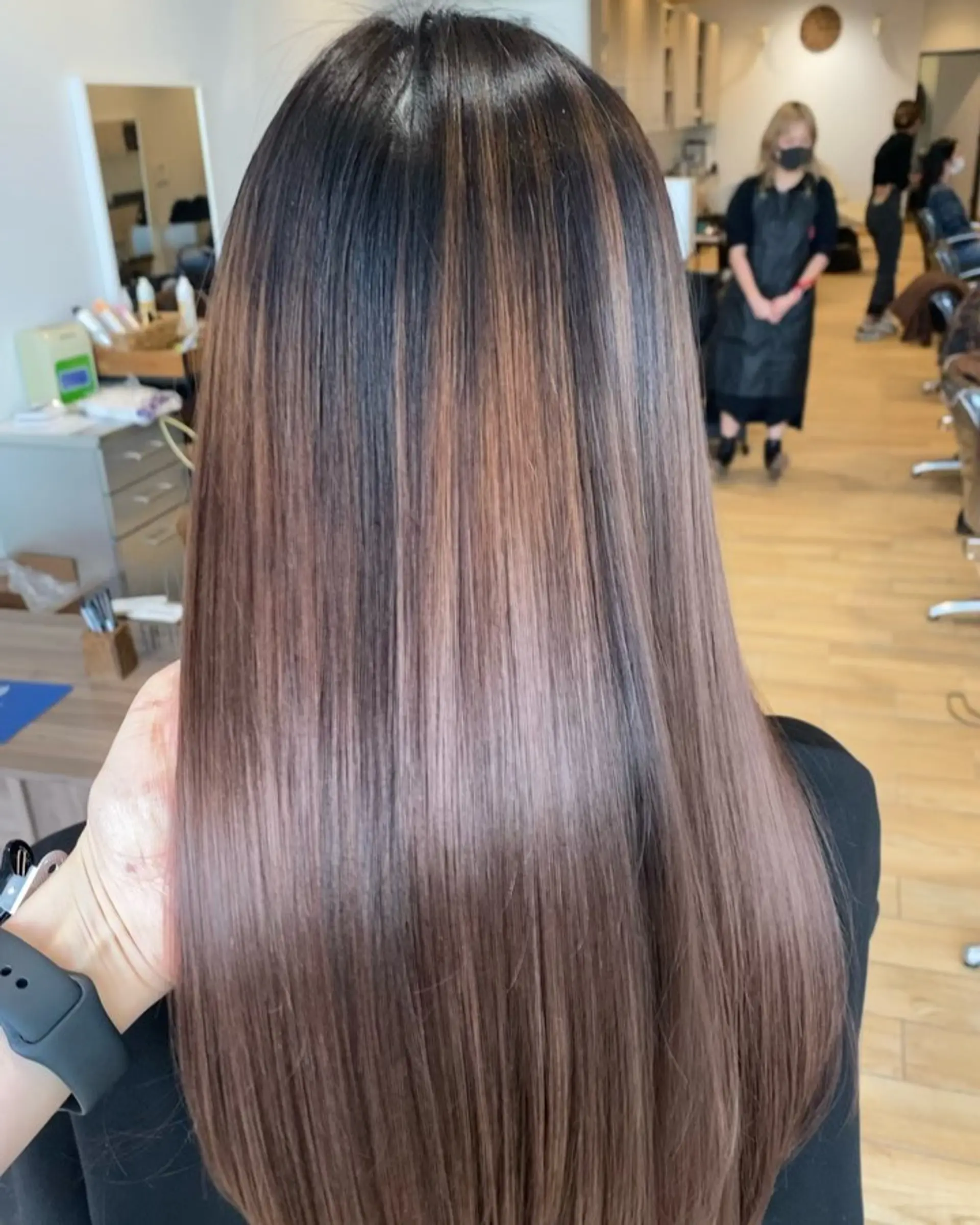 Long, pin-straight hair showcasing smooth ash brown and caramel balayage highlights over a dark base. 1