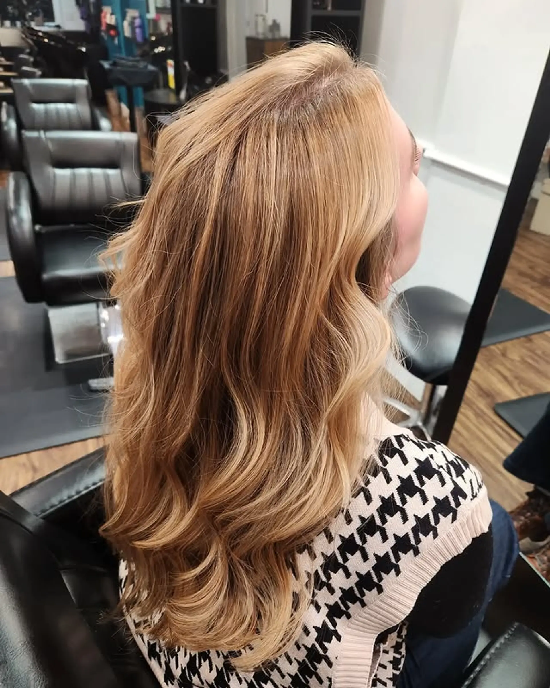 Long, wavy hairstyle with layers and face-framing. 1