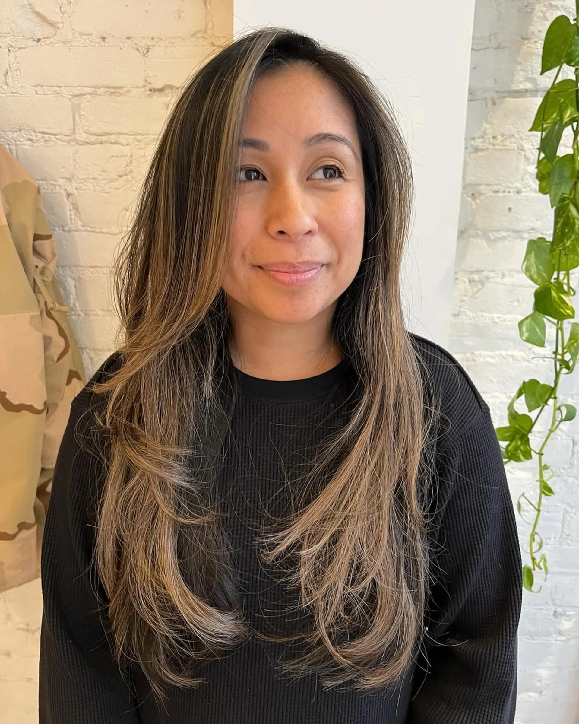 A woman with a modern shag haircut and curtain bangs, showcasing a key 2025 NYC hair trend. - Preview 3