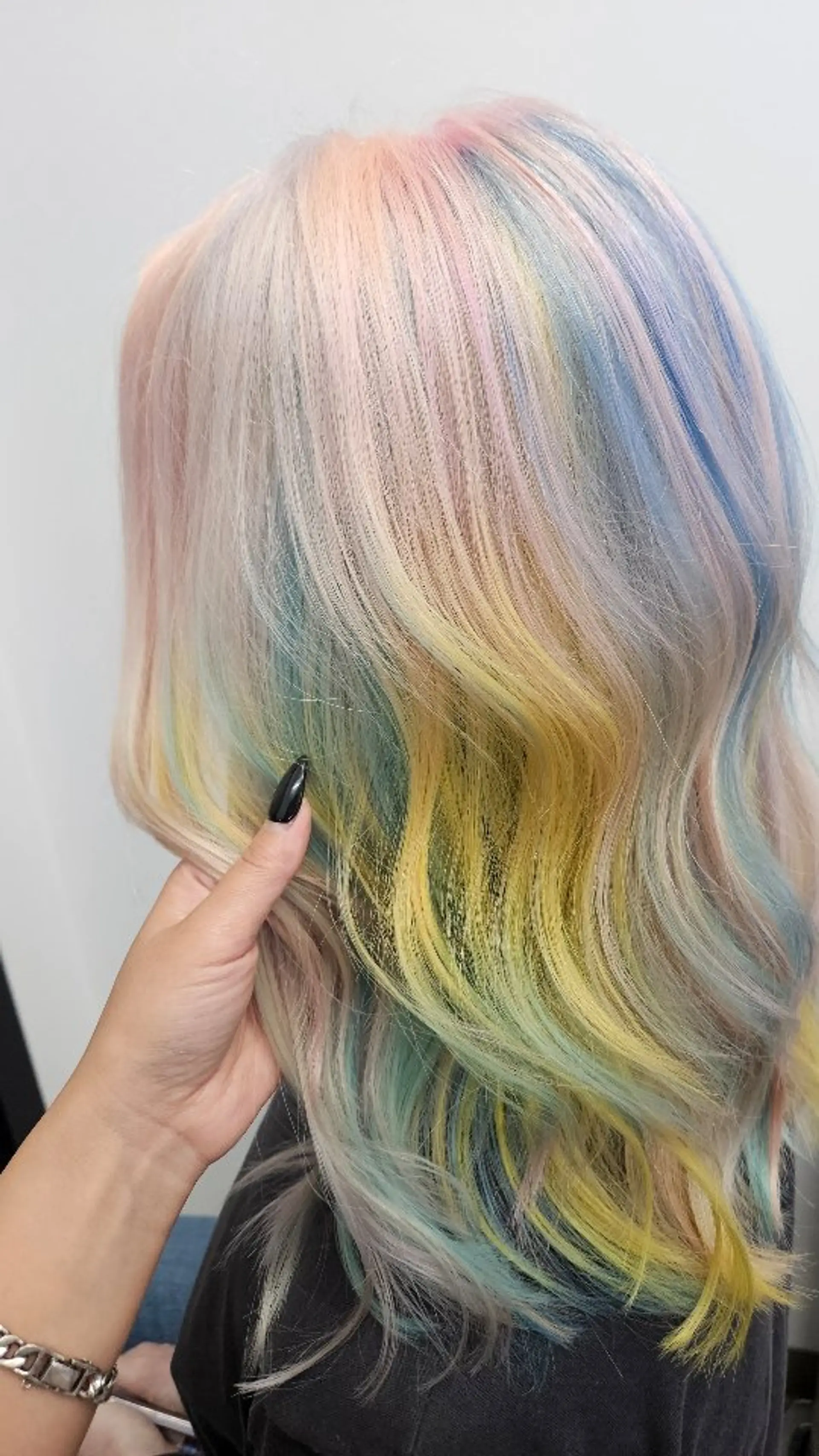 A multi-tonal pastel rainbow color melt featuring soft shades of pink, yellow, mint green, and sky blue styled in loose, gentle waves. 1