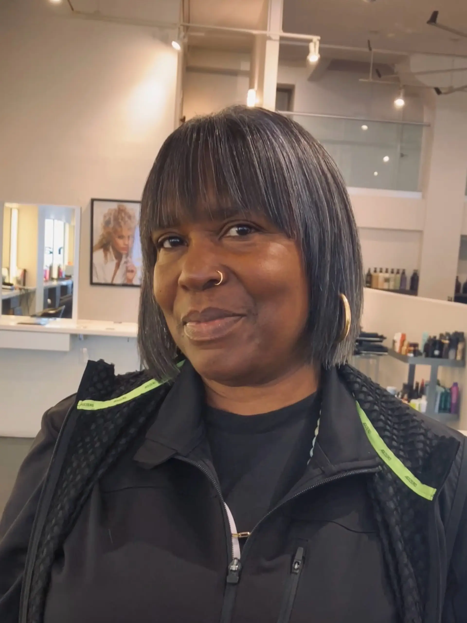 A sleek chin-length bob haircut styled straight with soft, textured eyebrow-length fringe. 1