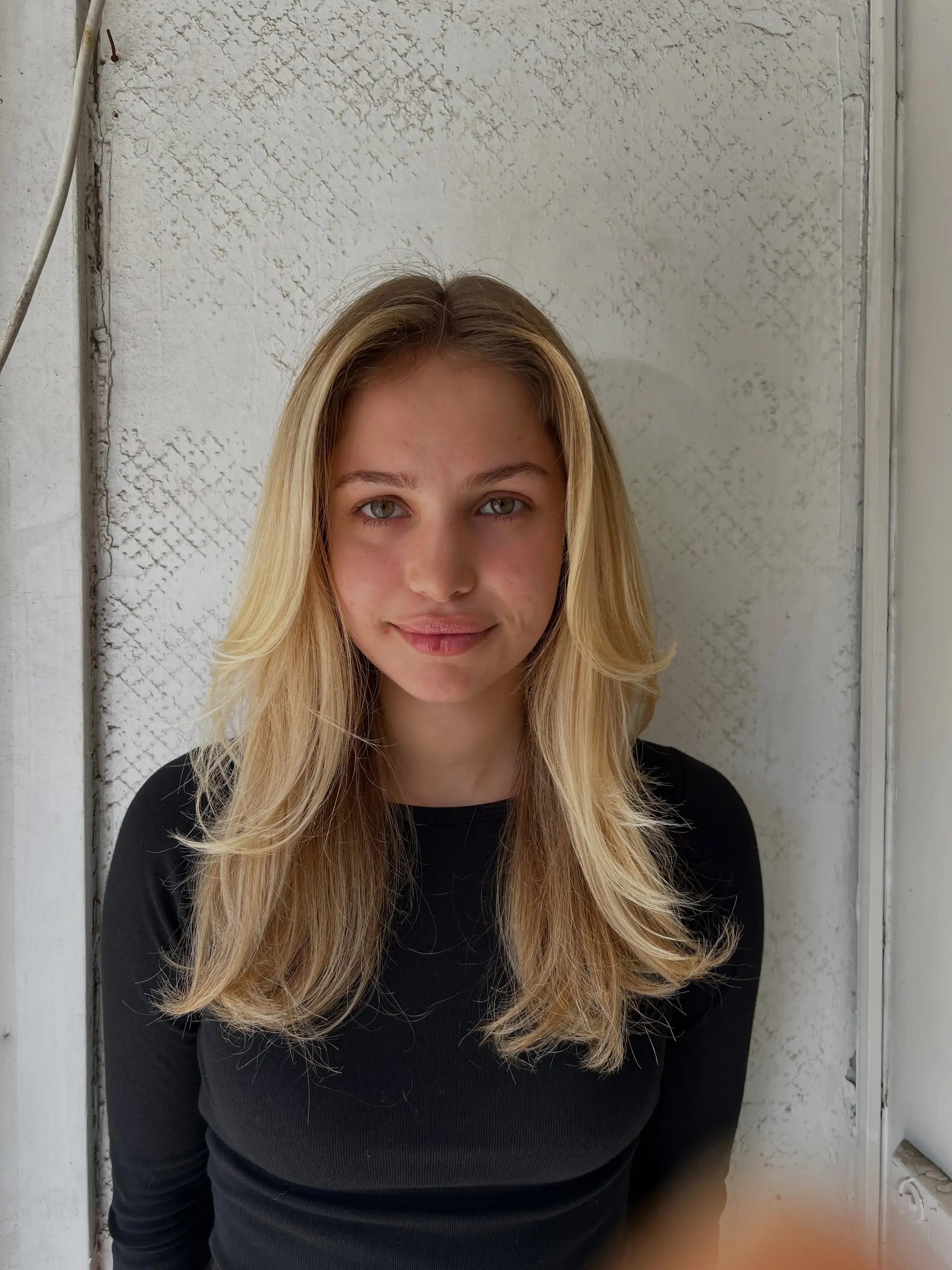A long layered cut styled with a smooth blowout and outward-flipped face-framing layers. 1