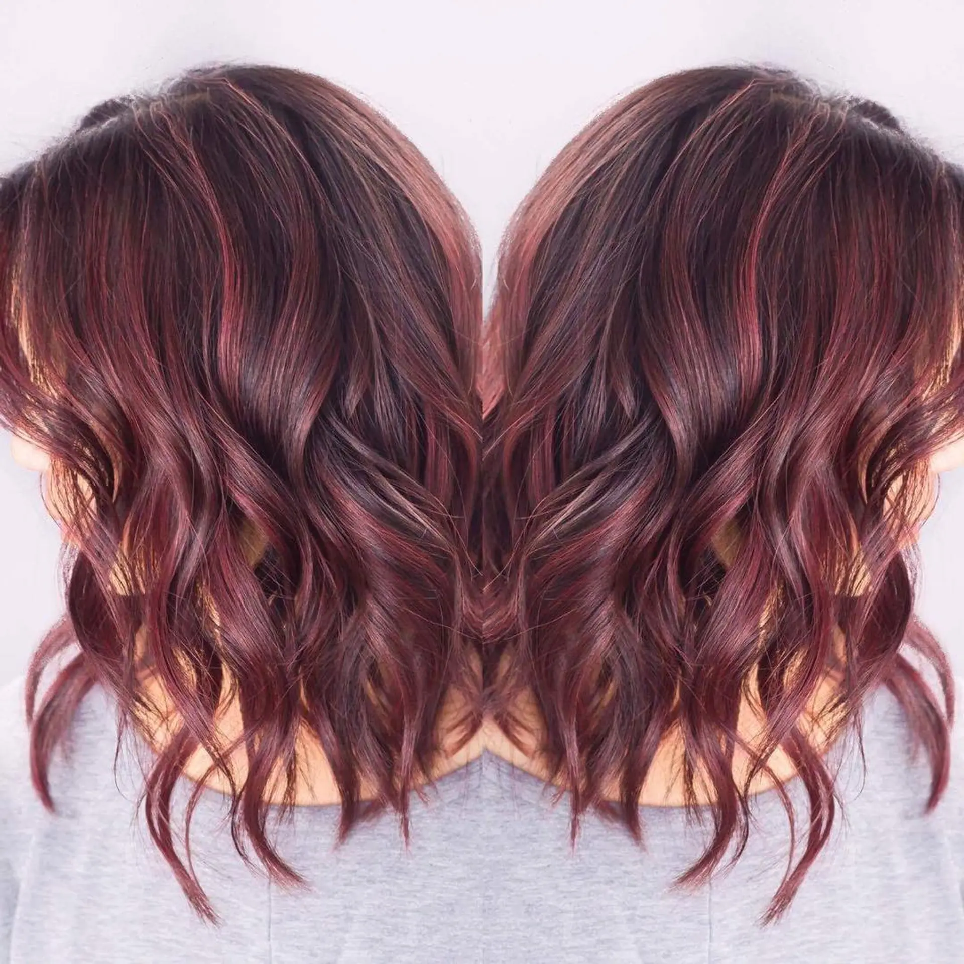 Medium-length textured wavy bob featuring rich red-violet highlights woven through a dark brown base. 1