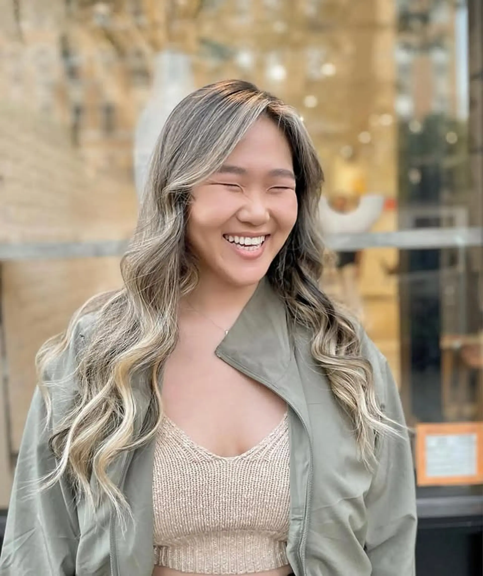 This hairstyle features medium length hair with soft waves and a bronde balayage. 1