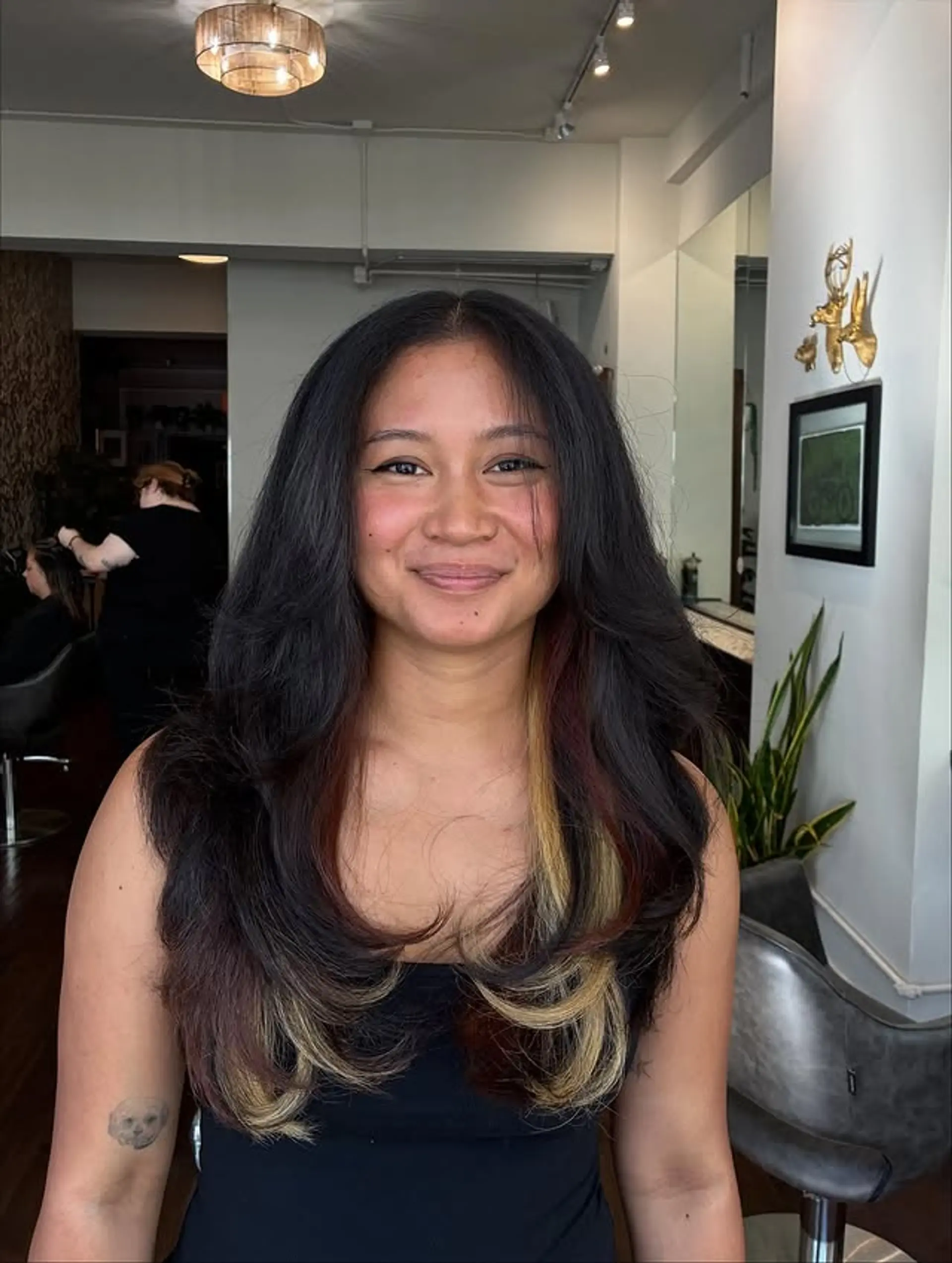 Long layered hairstyle with face-framing highlights. 1