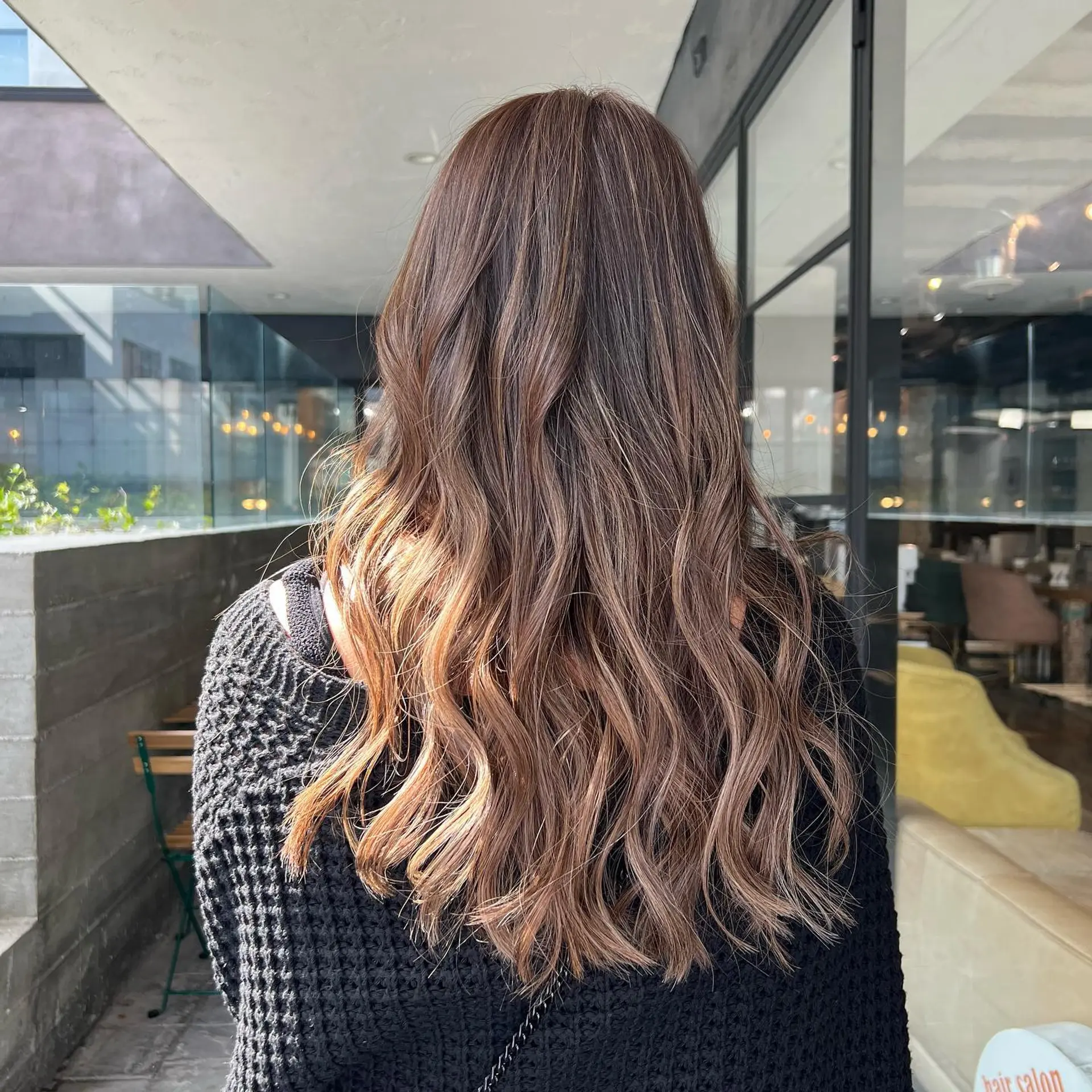 Long, layered, wavy hairstyle with a bronde balayage. 2