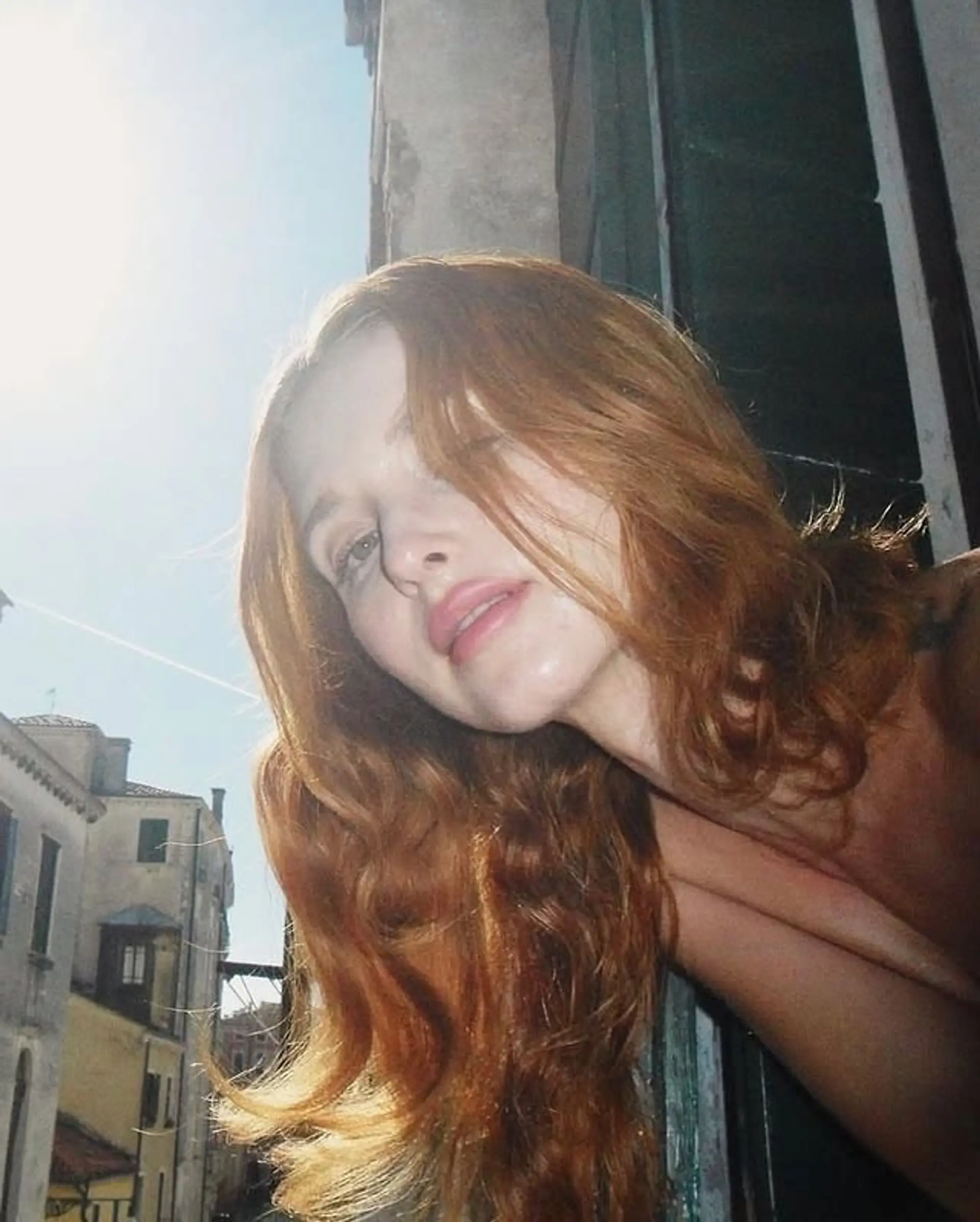 Long layered hairstyle with loose waves and face-framing layers. 1