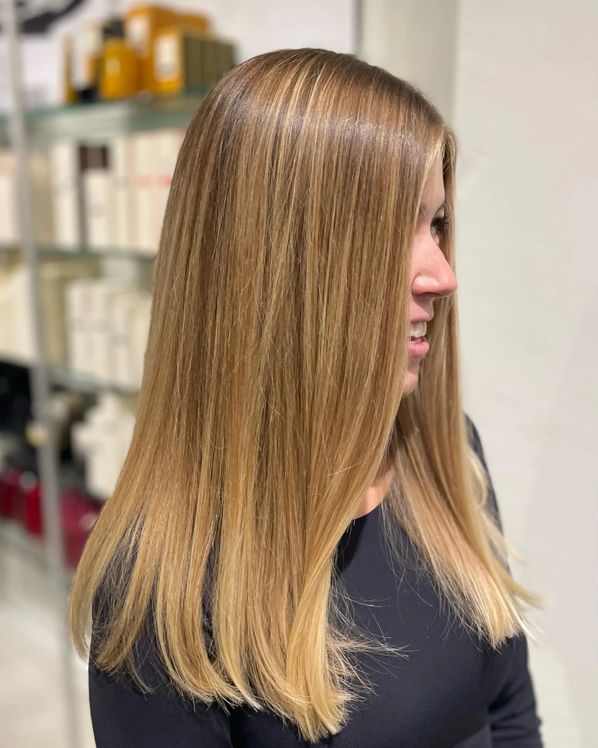 Sleek, straight long hair featuring seamless warm golden blonde balayage highlights blended over a natural light brown base. 1