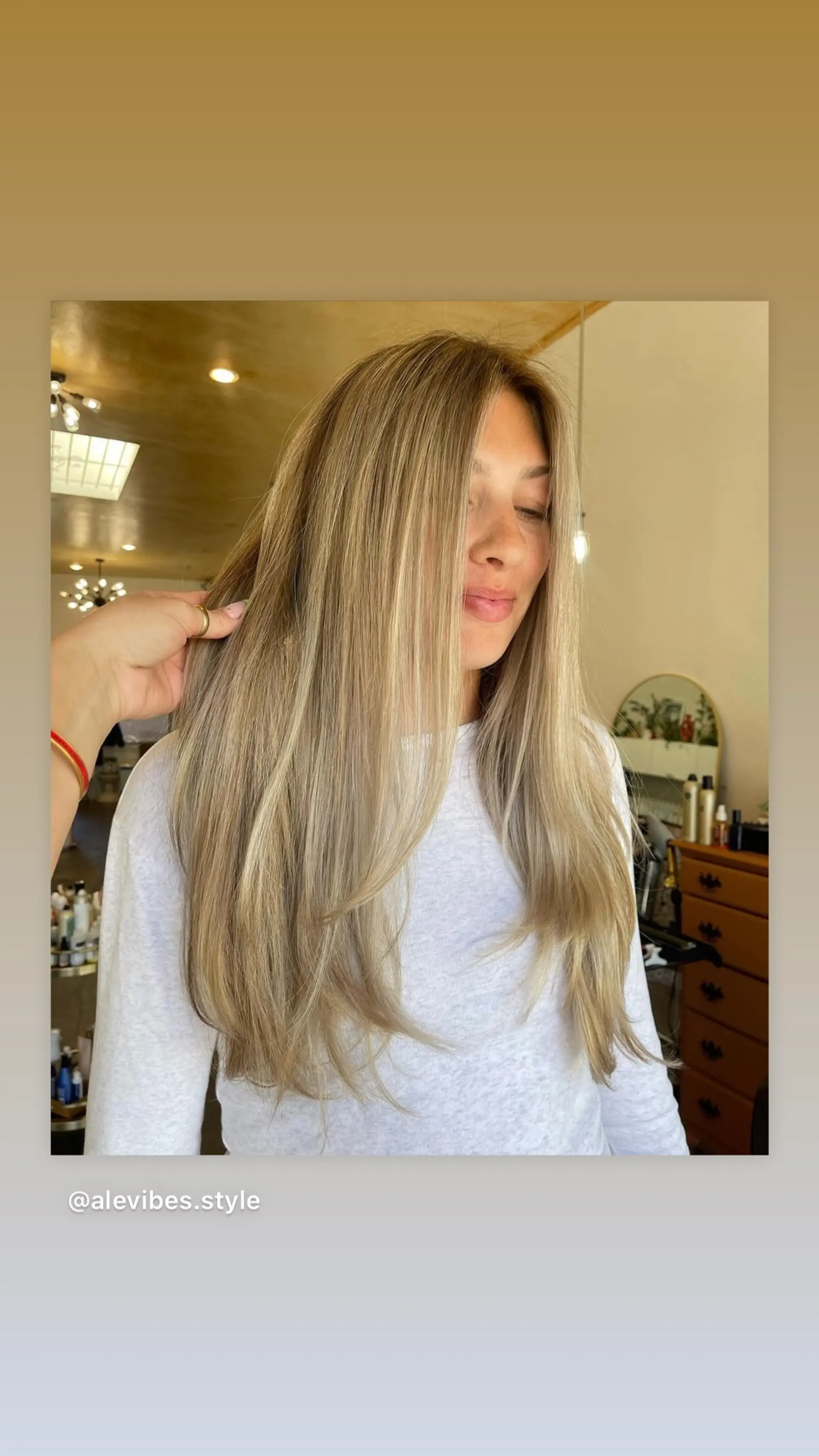 A long, layered haircut with dimensional honey blonde coloring. 1