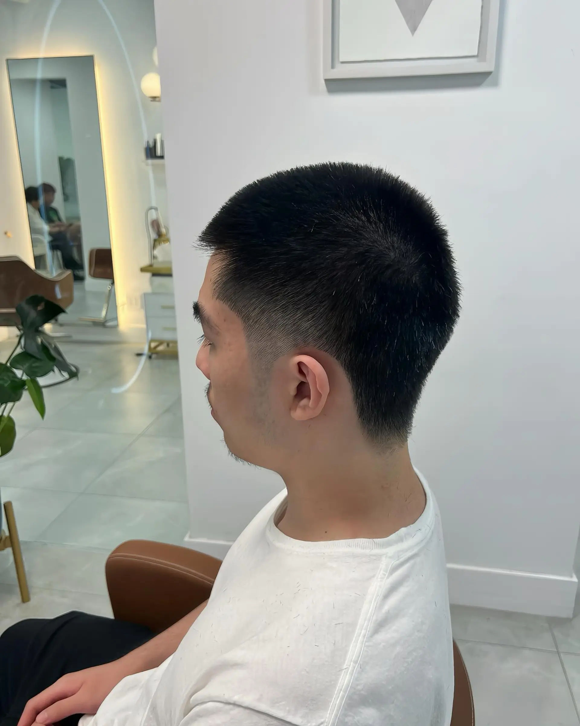 A classic buzz cut with a modern taper fade, offering a clean and low-maintenance style. 1